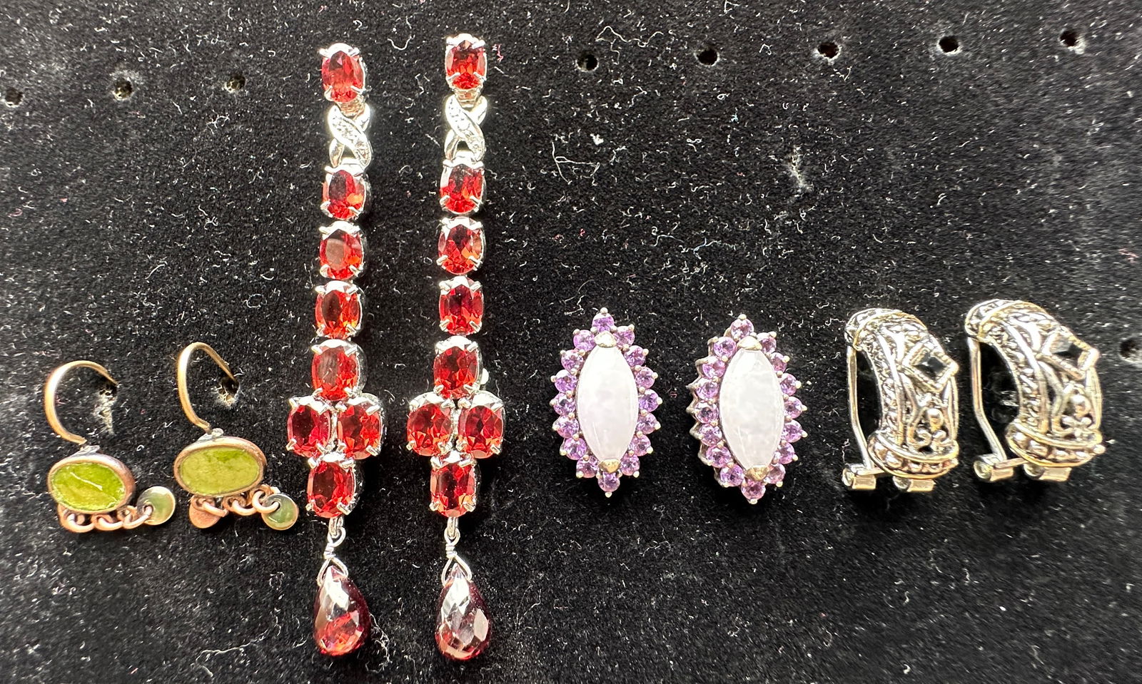 Four Pairs of Fashion Earrings: Includes four pairs of fashion earrings. One pair features green stones, another red stones, a third with purple stones, and the last with black stones. Longest pair measures approximately 2.75