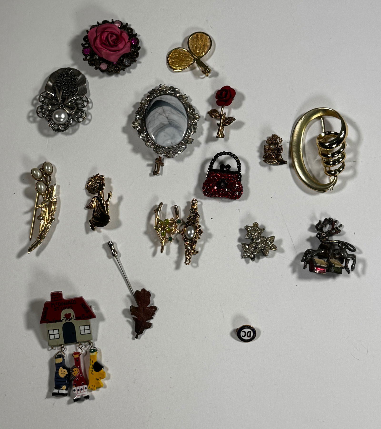 Vintage Costume Brooch Lot: Collection of vintage costume brooches. Includes floral, figural, and abstract designs. Largest brooch measures approximately 2.25 inches. Total weight approximately 5 oz.