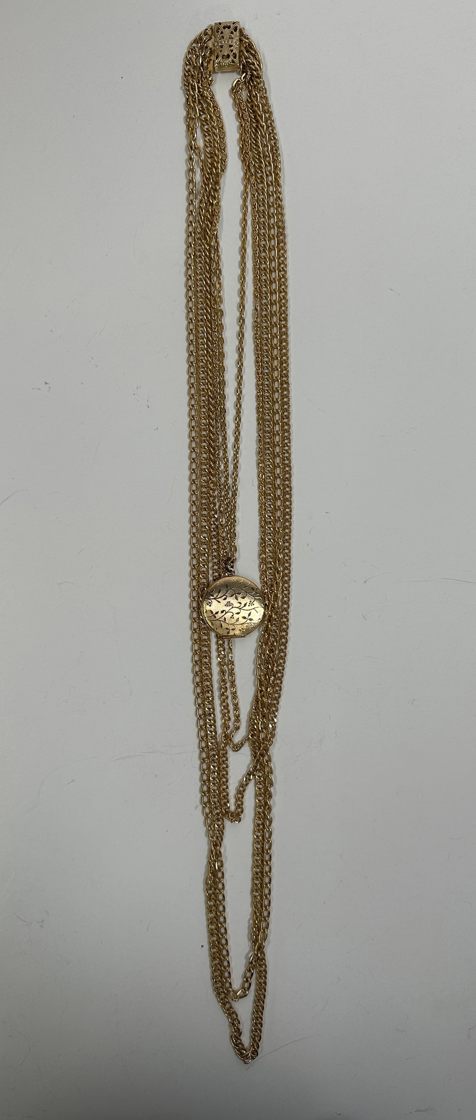 Gold Tone Multi-Strand Necklace with Medallion: Gold tone multi-strand necklace featuring a central medallion. Weight: 2.9 oz. 
