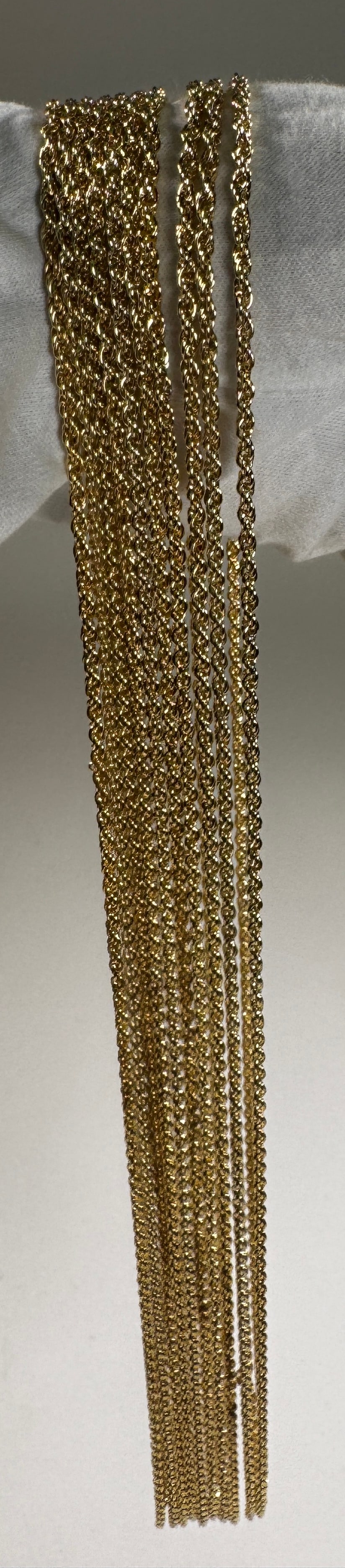 Group of Gold Tone Metal Chains: A group of gold tone metal chains. Weight: 5 oz. Longest chain approximately 15 inches.