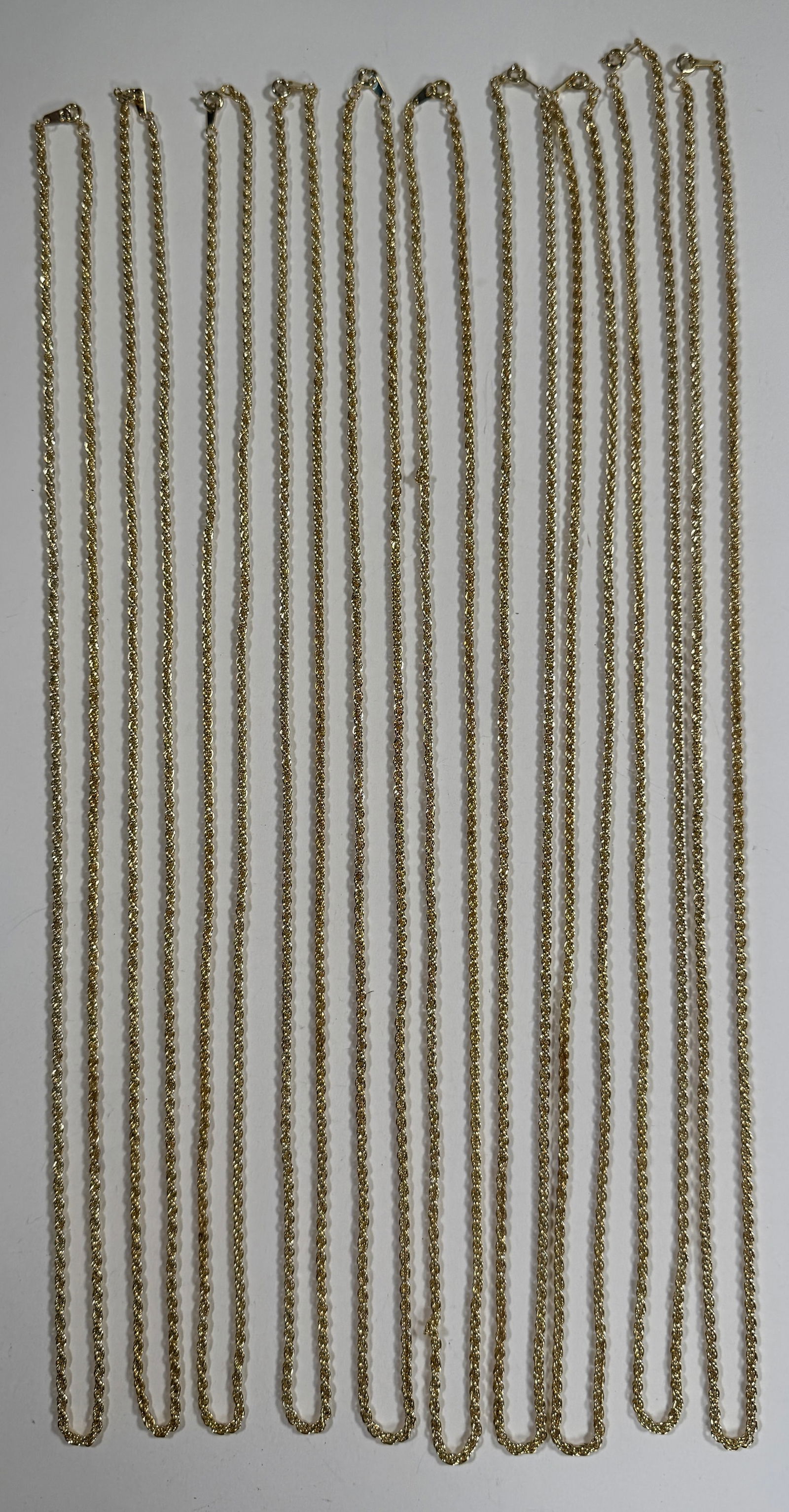 Group of Costume Jewelry Chains: Collection of costume jewelry chains. Total weight approximately 5 oz. Longest chain measures approximately 15 inches.