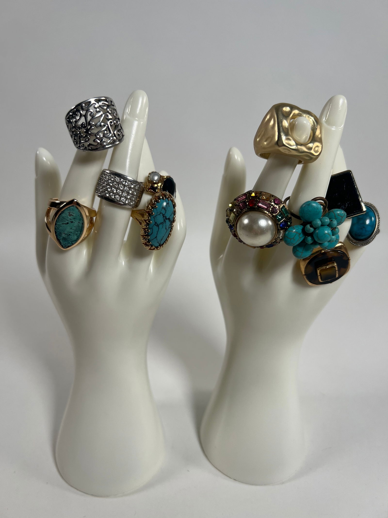 Costume Rings: Collection of costume rings featuring various designs and materials, including turquoise, faux pearl, and geometric shapes. Two of the rings feature sterling silver bands. Weight: 4.2 oz. Sizes: