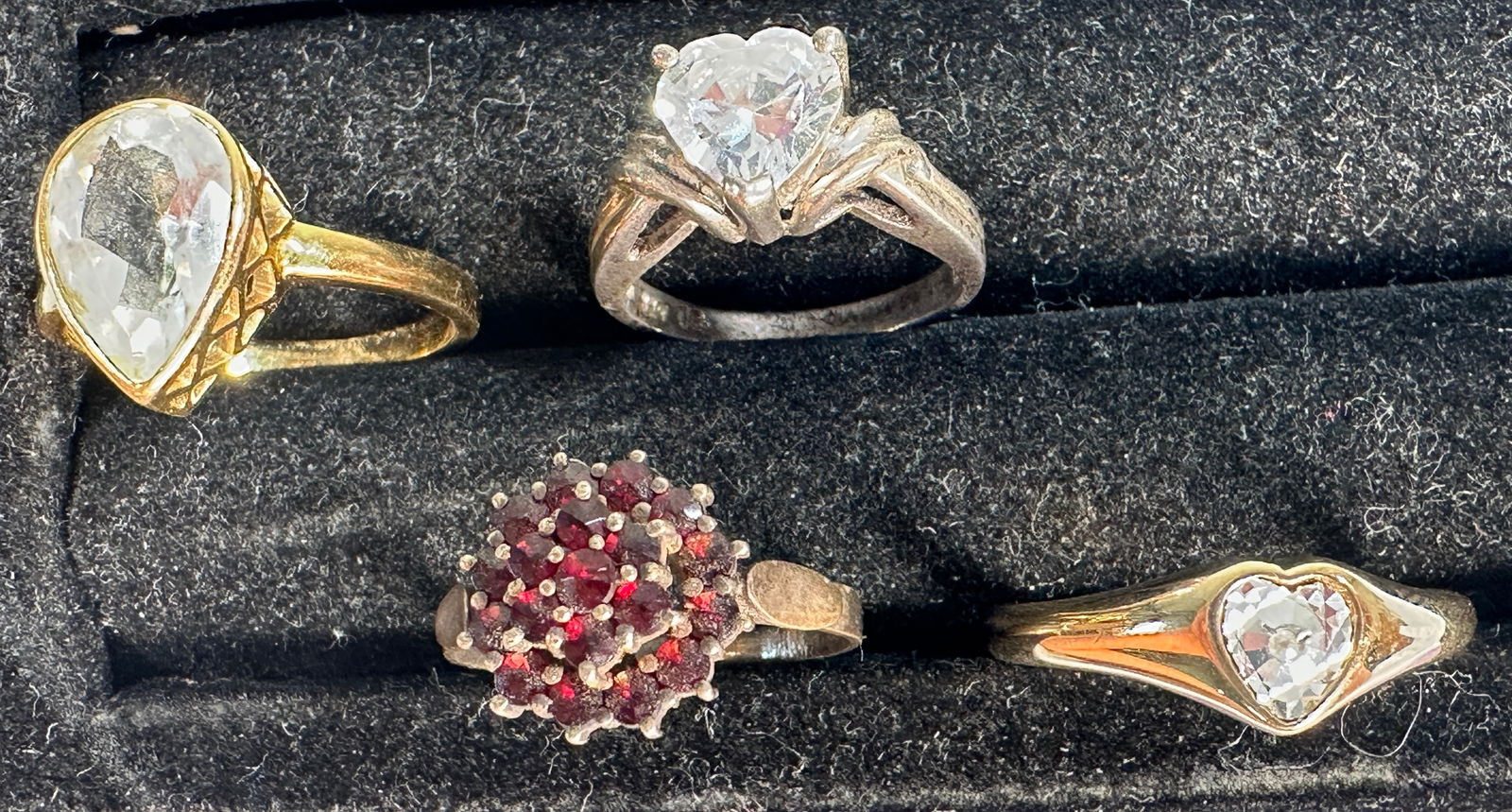 Four Assorted Costume Rings: Collection of four costume rings featuring various stones and metal finishes. Ring sizes: 6.25, 8, 7.75, 8.25.