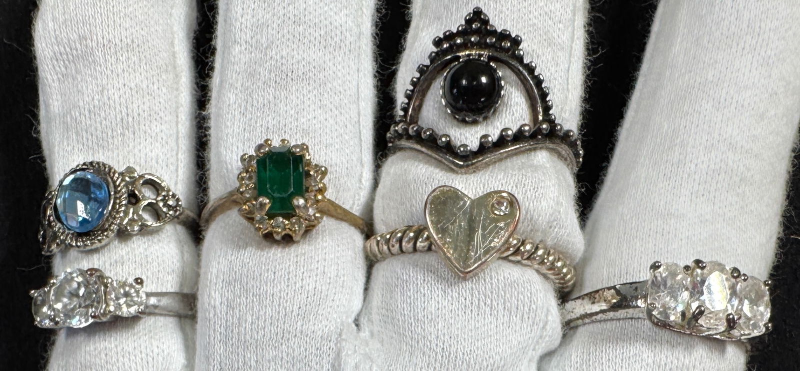 Six Assorted Fashion Rings: This lot features six assorted fashion rings. The rings feature various stones and designs. Ring sizes include 6.75, 8.75, 10.75, 4.5, 5.75, and 6.5. Total weight: 0.7 oz.