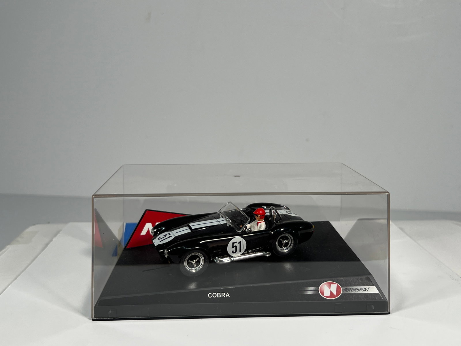 Ninco AC Cobra Black #51: Ninco AC Cobra #51 1/32 Slot Car, with original case. Weight: 9 oz.