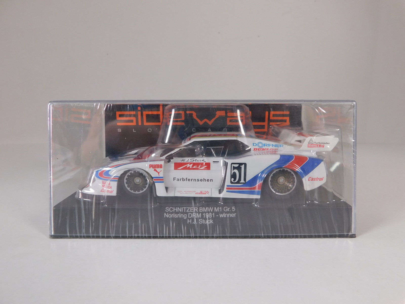 Sideways Schnitzer BMW M1 Gr.5 Norisring DRM 1981 Winner #51: Sideways Schnitzer BMW M1 Gr.5 Norisring DRM 1981 winner H.J. Stuck #51 Dorfner 1/32 Slot Car. Reference #SW25, with original case. Weight: 7.1 oz. Shrink-wrapped, new in box.