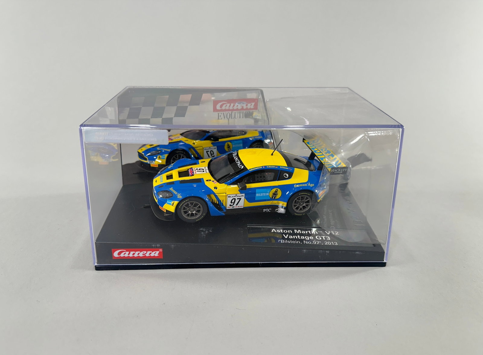 Carrera Evolution Aston Martin V12 Vantage GT3: Carrera Evolution Aston Martin V12 Vantage GT3 slot car, #97, in original packaging. Scale 1/32. Weight 16 oz. Dimensions: 8'' x 5 1/8'' x 4''. 