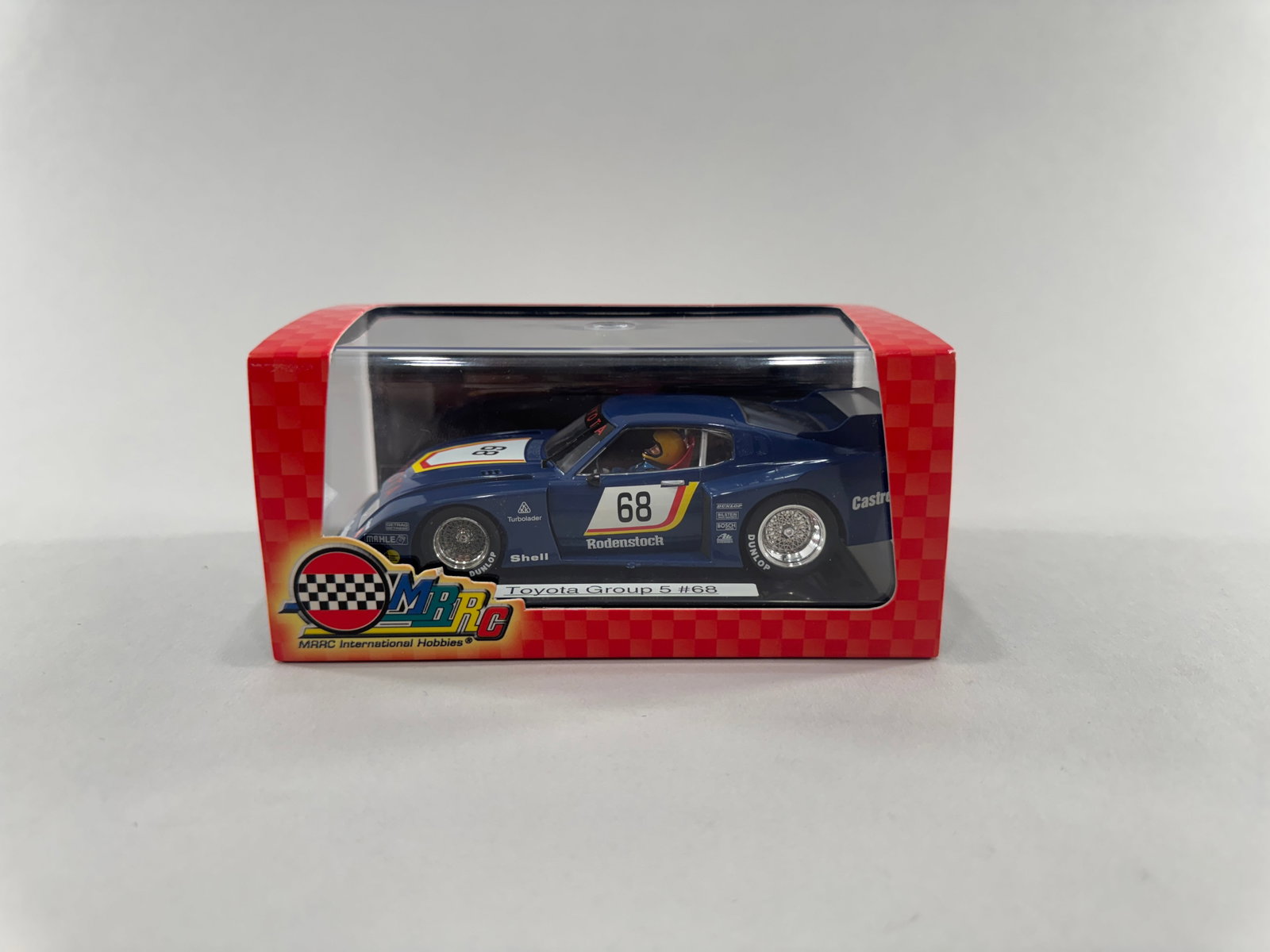 MRRC Toyota Celica LB Turbo Group 5 #68: A 1:32 scale slot car model of the Toyota Celica LB Turbo Group 5, number 68, by MRRC International Hobbies. This model features a blue livery with racing decals and is presented in its original