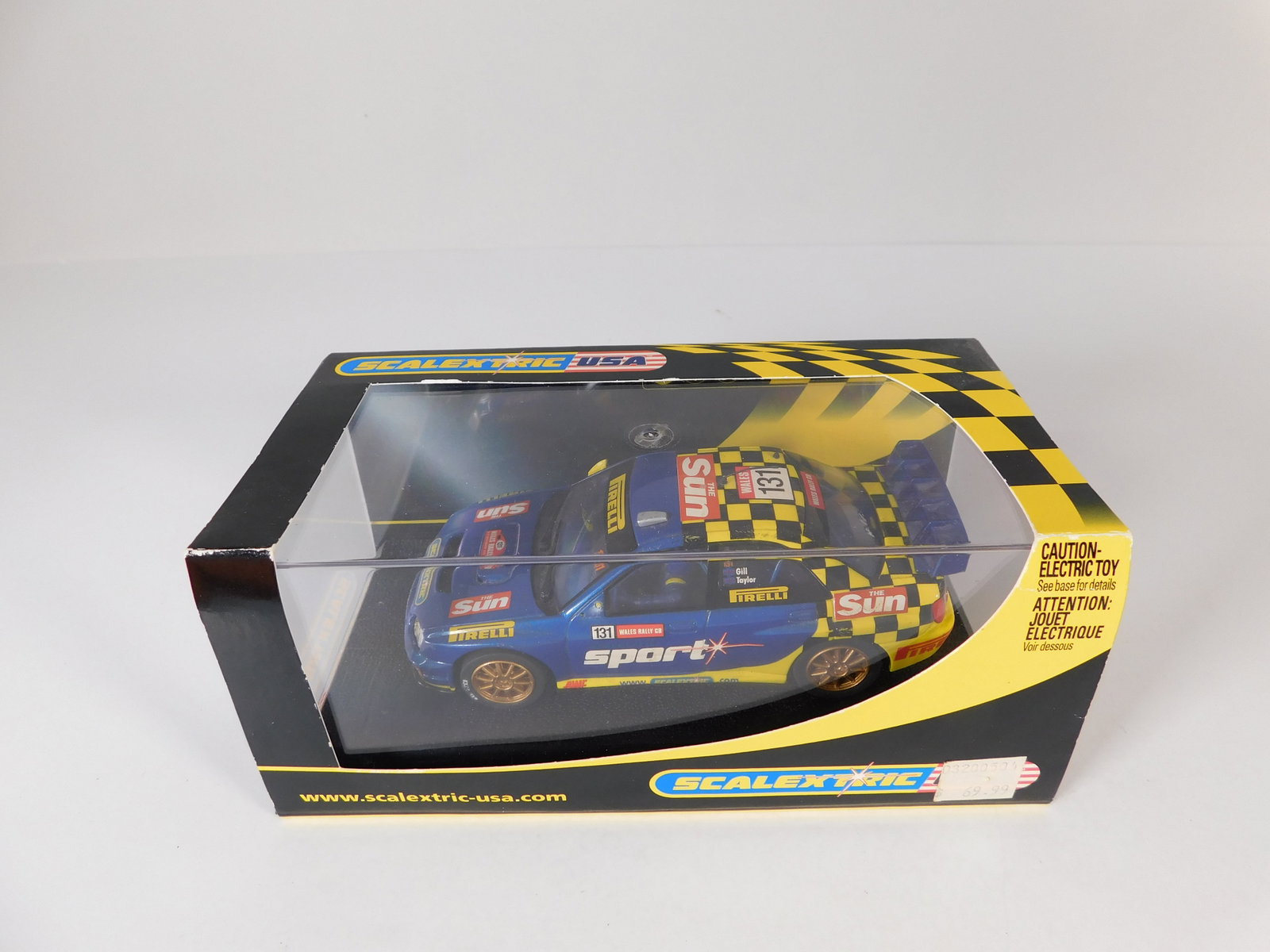 Scalextric USA Subaru Impreza WRC #131: Scalextric USA Subaru Impreza WRC The Sun #131 Sport 1/32 Slot Car. Reference #C2550, with original case. Weight: 8.2 oz.