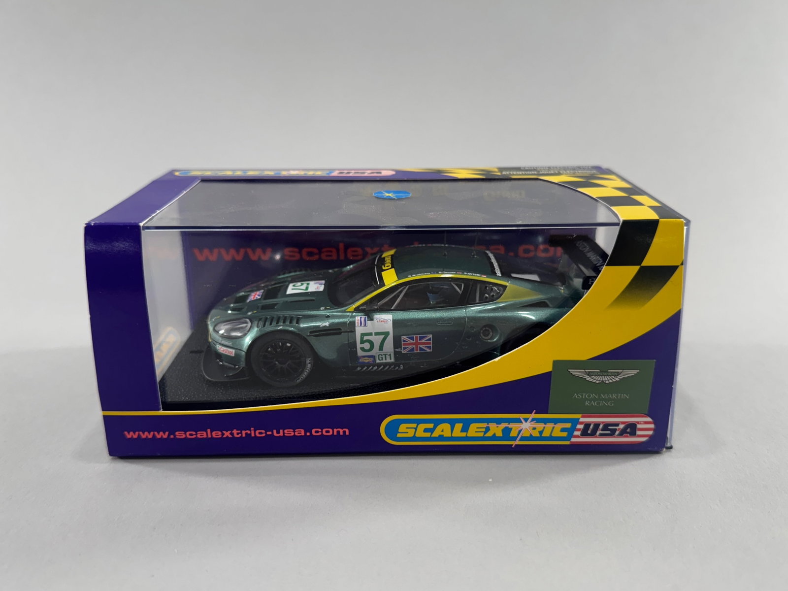 Scalextric USA Aston Martin DBR9 #57: Scalextric USA Aston Martin DBR9 #57 1/32 scale slot car, model number C2644. Weight 8.1 oz. Dimensions: 7'' x 3.5'' x 3''. 