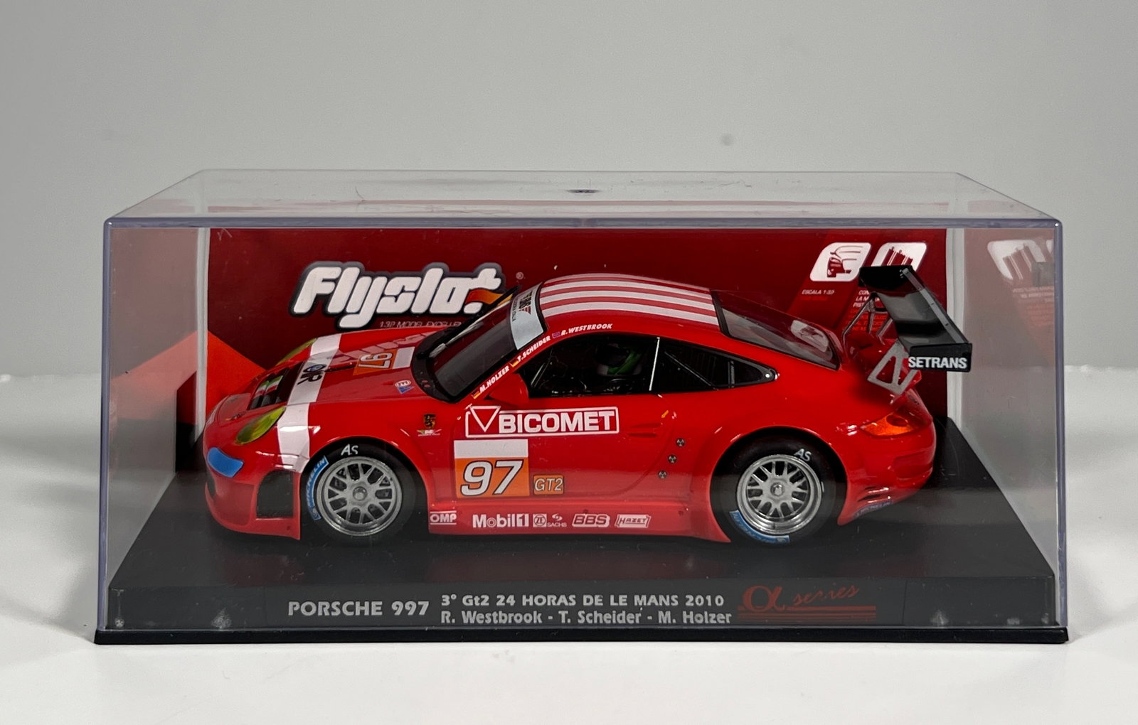 Flyslot Porsche 997 GT2 Le Mans 2010 #97: Flyslot Porsche 997 3rd GT2 24h de Le Mans 2010 Westbrook - Schelder - Holzer #97 Bicomet 1/32 Slot Car. Reference #704102, with original case. Dimensions: 3 x 6.5 inches. Weight: 6 oz.