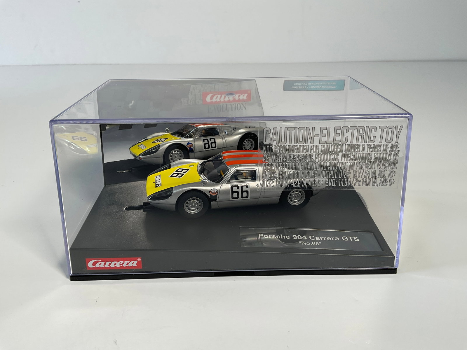 Carrera Evolution Porsche 904 Carrera GTS #66: Carrera Evolution Porsche 904 Carrera GTS #66 1/32 Slot Car, with original case. Case measures approximately 4 inches tall. Weight: 14.8 oz. Digitally upgradeable.