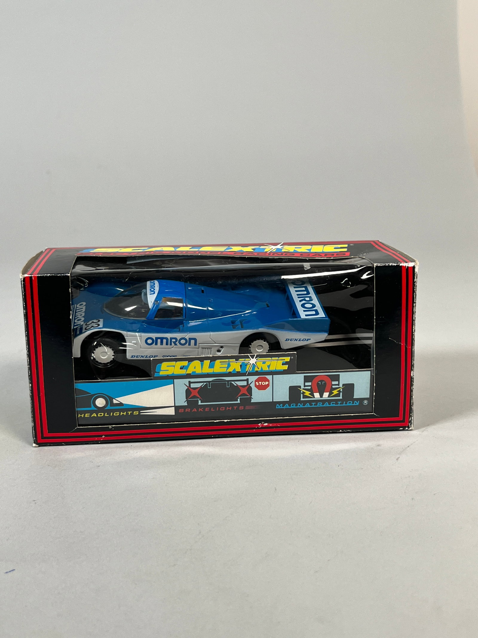 Scalextric Porsche 962 Omron #33: Scalextric Porsche 962 C.402 Omron 1/32 slot car, presented in its original box. Weight 6 oz. Dimensions: 4'' x 8'' x 3.25''. 
