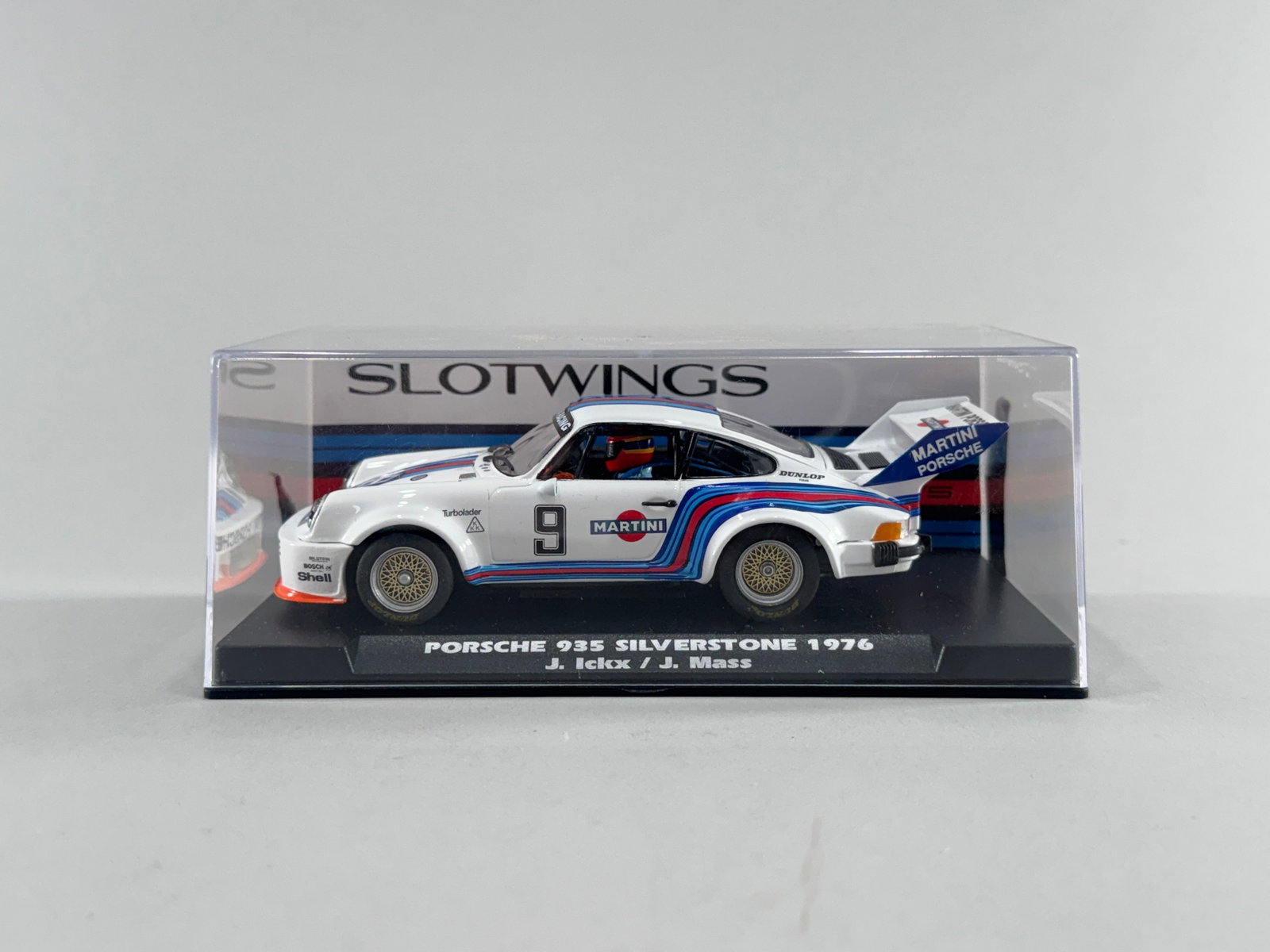 Slotwings Porsche 935 Silverstone 1976 #9: Slotwings Porsche 935 Silverstone 1976 J. Ickx / J. Mass #9 Martini 1/32 Slot Car, in its original display case. Dimensions: 6 9/16 x 3 1/2 x 2 5/8''. Weight: 6.5oz. 