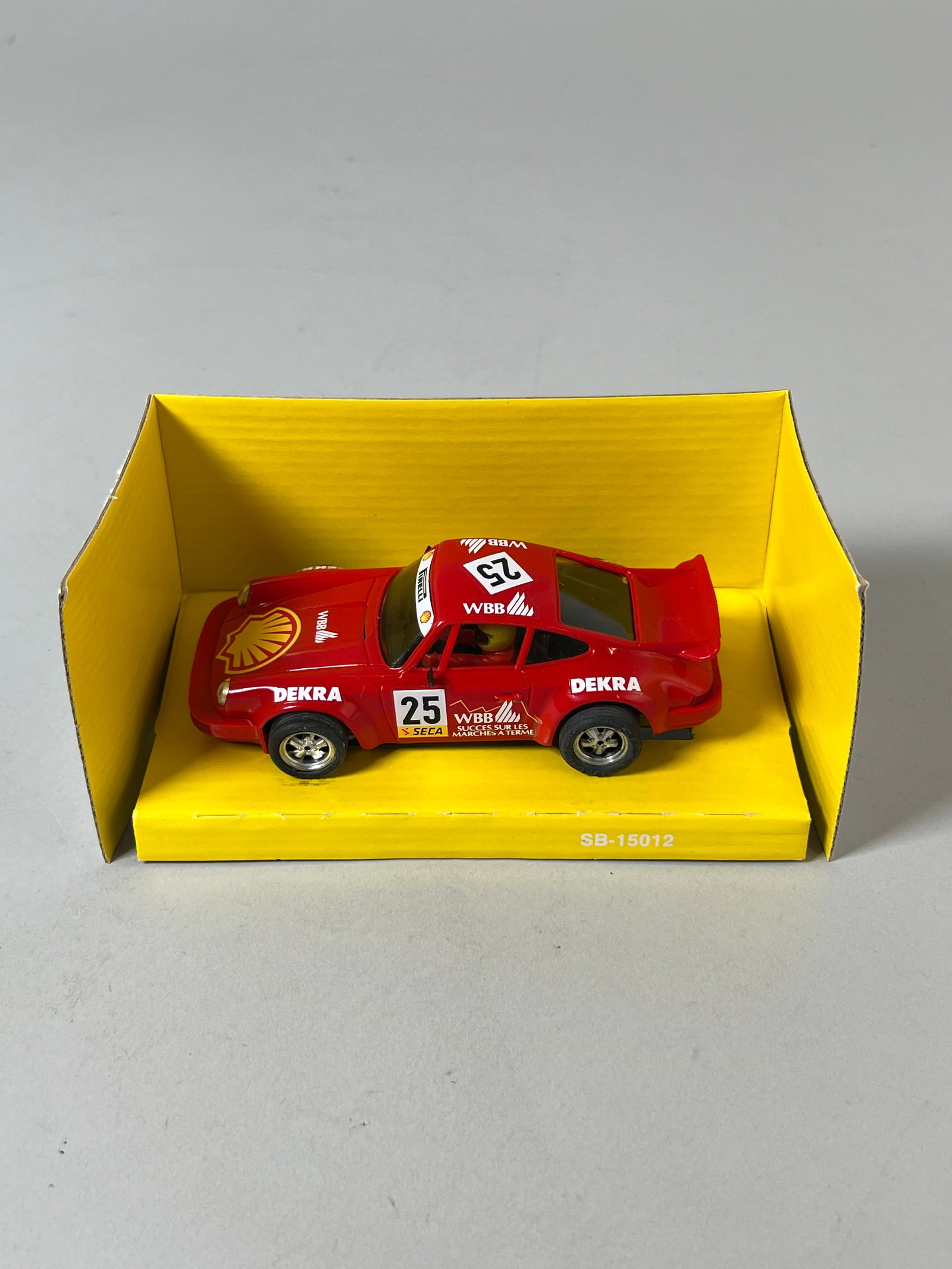 SCX Porsche 911 "Shell" #25: SCX Porsche 911 "Shell" #25 1/32 Slot Car. Includes original box and maintenance instructions. Dimensions: 3.75" x 6.75" x 3.5". Weight: 5.2oz.