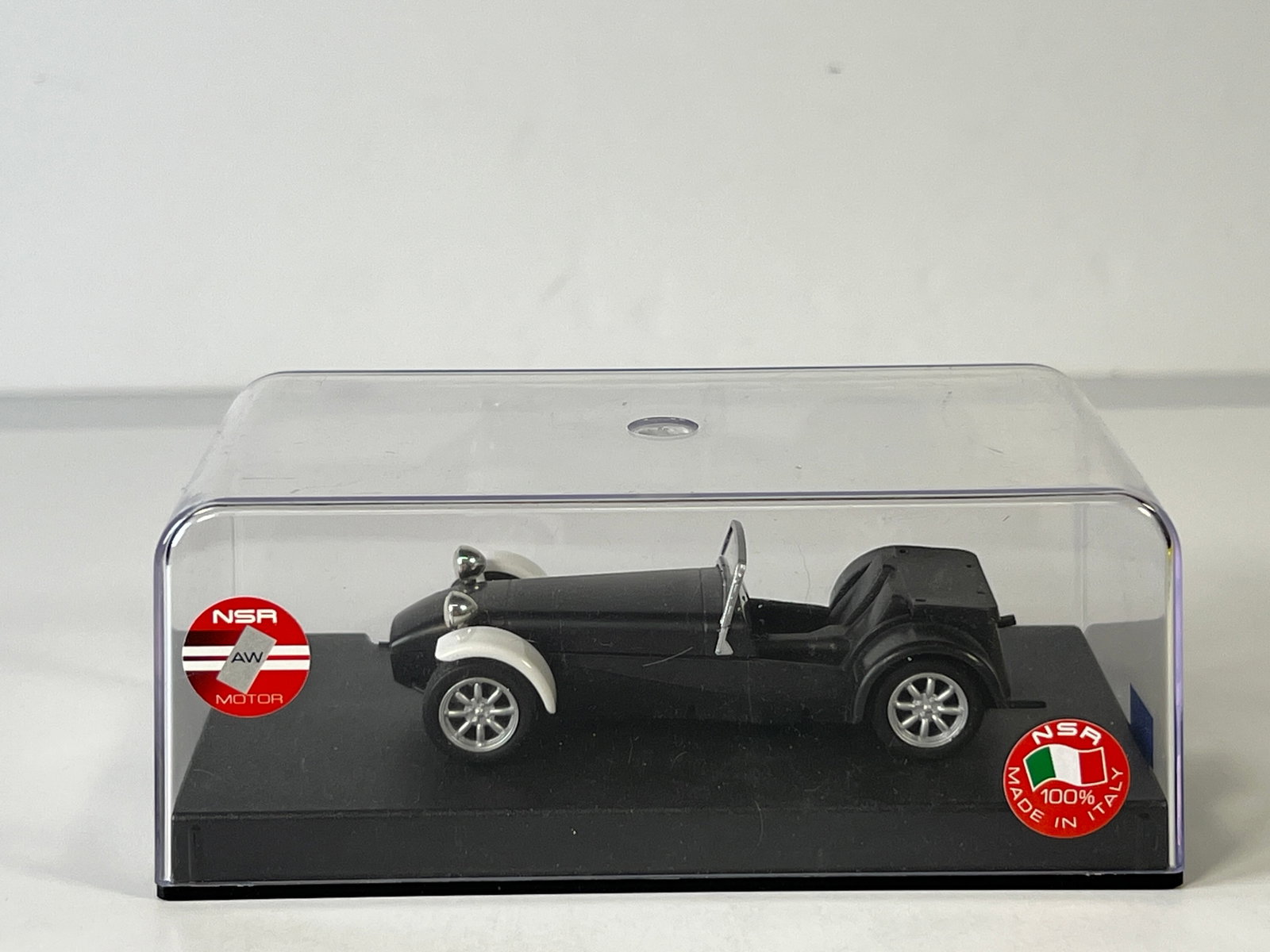 Lotus Super Seven Slot Car: Lotus Super Seven 1/32 Slot Car, with original case. Case measures 6.5 inches in length and the total weight is 5 ounces. Car is not in original packaging.