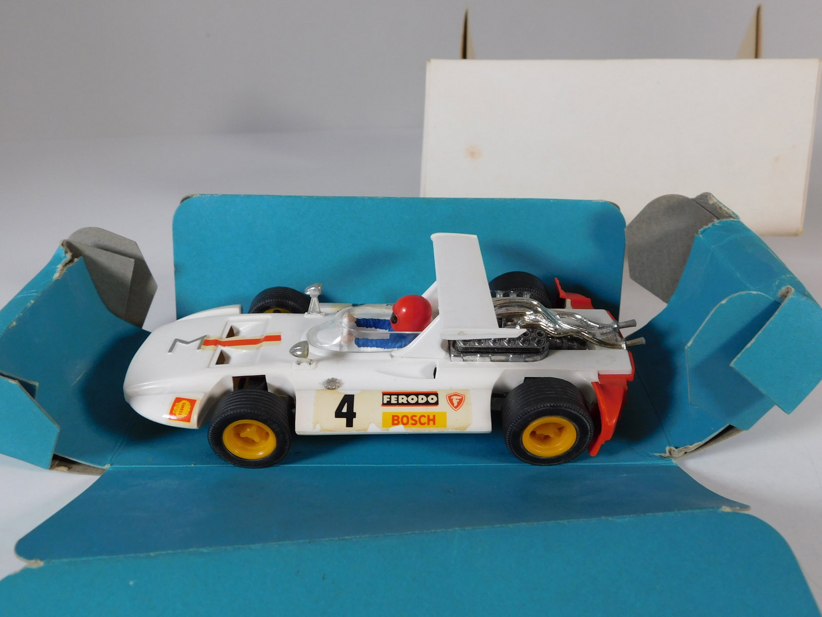 Vintage Scalextric Exin C-4047 Sigma #4: Scalextric Model Motor Racing Exin C-4047 Sigma #4 Bosch 1/32 Slot Car, with original case. Weight: 6.2 oz.