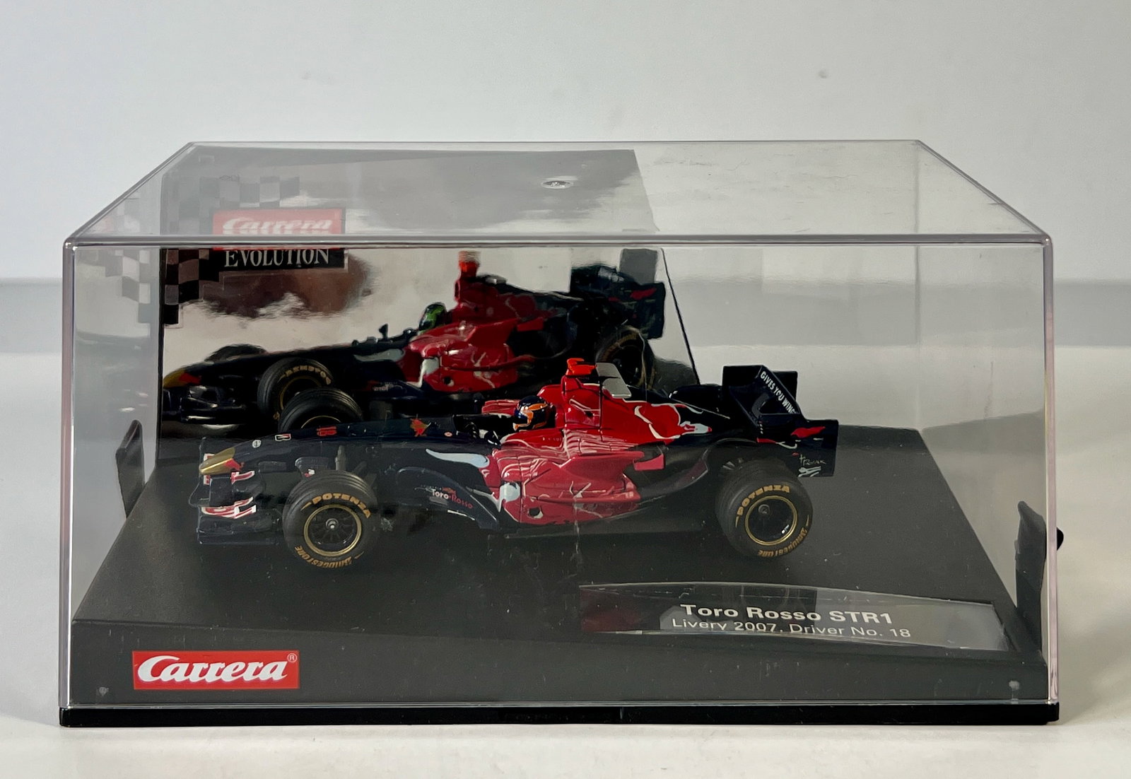 Carrera Evolution Toro Rosso STR1 #18: Carrera Evolution Toro Rosso STR1 Livery 2007 Driver #18 RedBull 1/32 Slot Car, with original case. Weight: 13 oz.