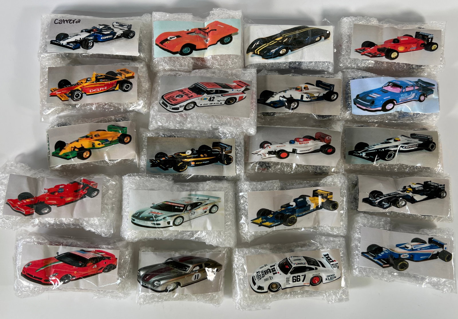 Twenty Loose 1/32 Scale Slot Cars: Twenty assorted slot cars from Nick's extensive collection. Various makes and models are represented. Photos match the cars in bubble wrap. Additional packaging is not included. Cars are ass