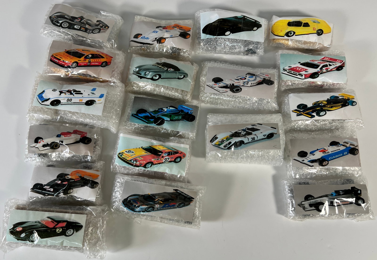 Nineteen Loose 1/32 Scale Slot Cars: Nineteen assorted slot cars from Nick's extensive collection. Various makes and models are represented. Photos match the cars in bubble wrap. Additional packaging is not included. Cars are a