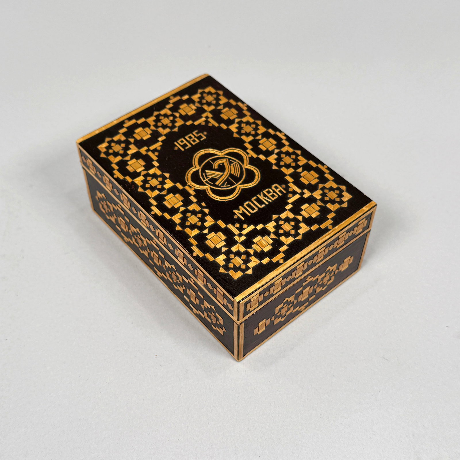 Belarusian/Russian Commemorative Straw Inlay Box: A commemorative stray inlay box created for the 1985 12th World Festival of Youth and Students in Moscow. Features the festival's 1985 emblem on the lid of the box along with the writing "198