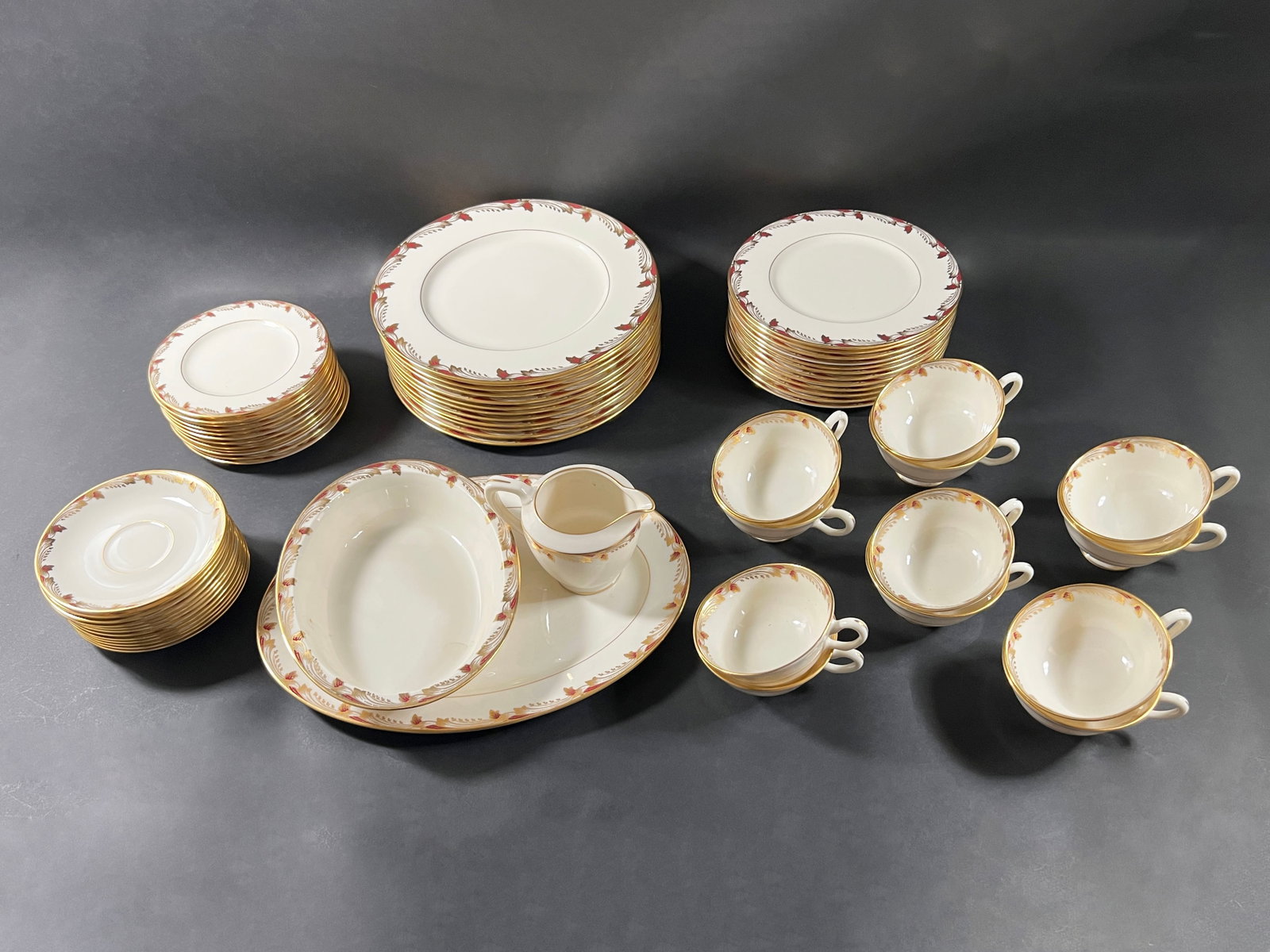China Set - Lennox Essex: A large china set featuring a floral and gold trim design. Includes plates, bowls, cups, saucers, a creamer, and serving dishes. Weight: 38lb 3oz. Largest item: 13.75''.
