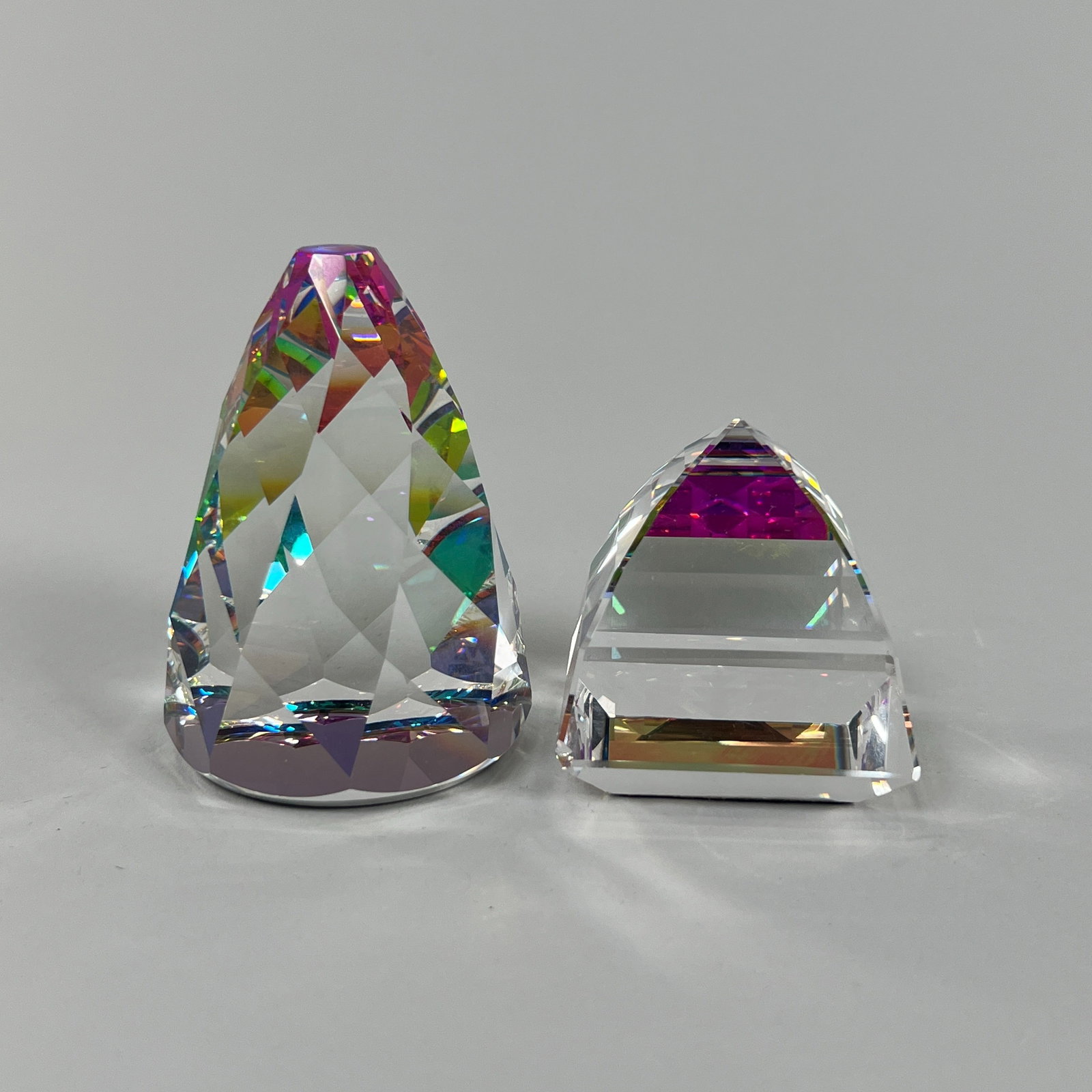 Two Crystal Paperweights: Two crystal paper weights. One is a Swarovski Crystal Rio Cone paperweight. Weight: 1lb 14oz. Tallest item: 3.25''. 
