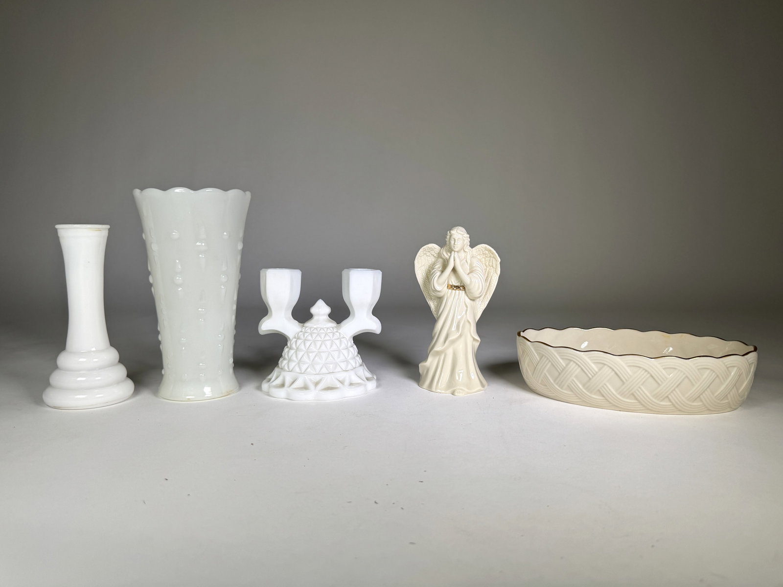 Collection of White and Cream Decorative Objects: A collection of decorative objects including two milk glass vases, a Lenox dish, a Lenox angel figurine, and a milk glass two-arm candelabra. The tallest item measures 7.25 inches. Total weight