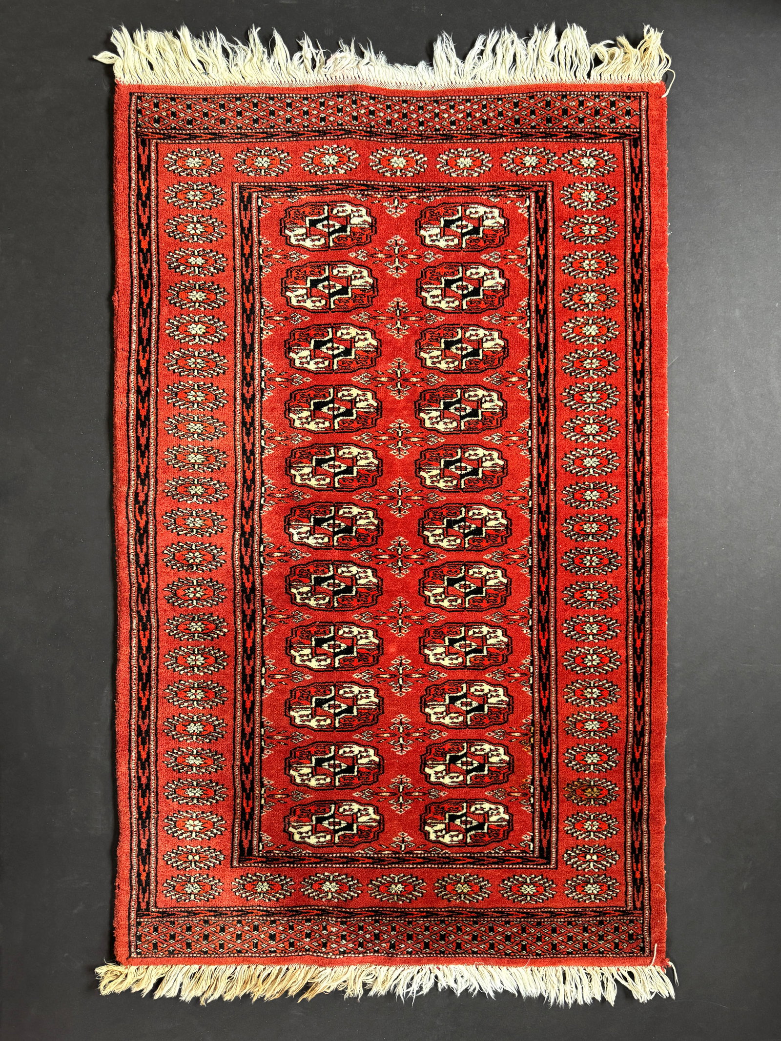 Bokara Rug: Hand-knotted wool Boukara rug, made in Pakistan. Dimensions: 31"x51"