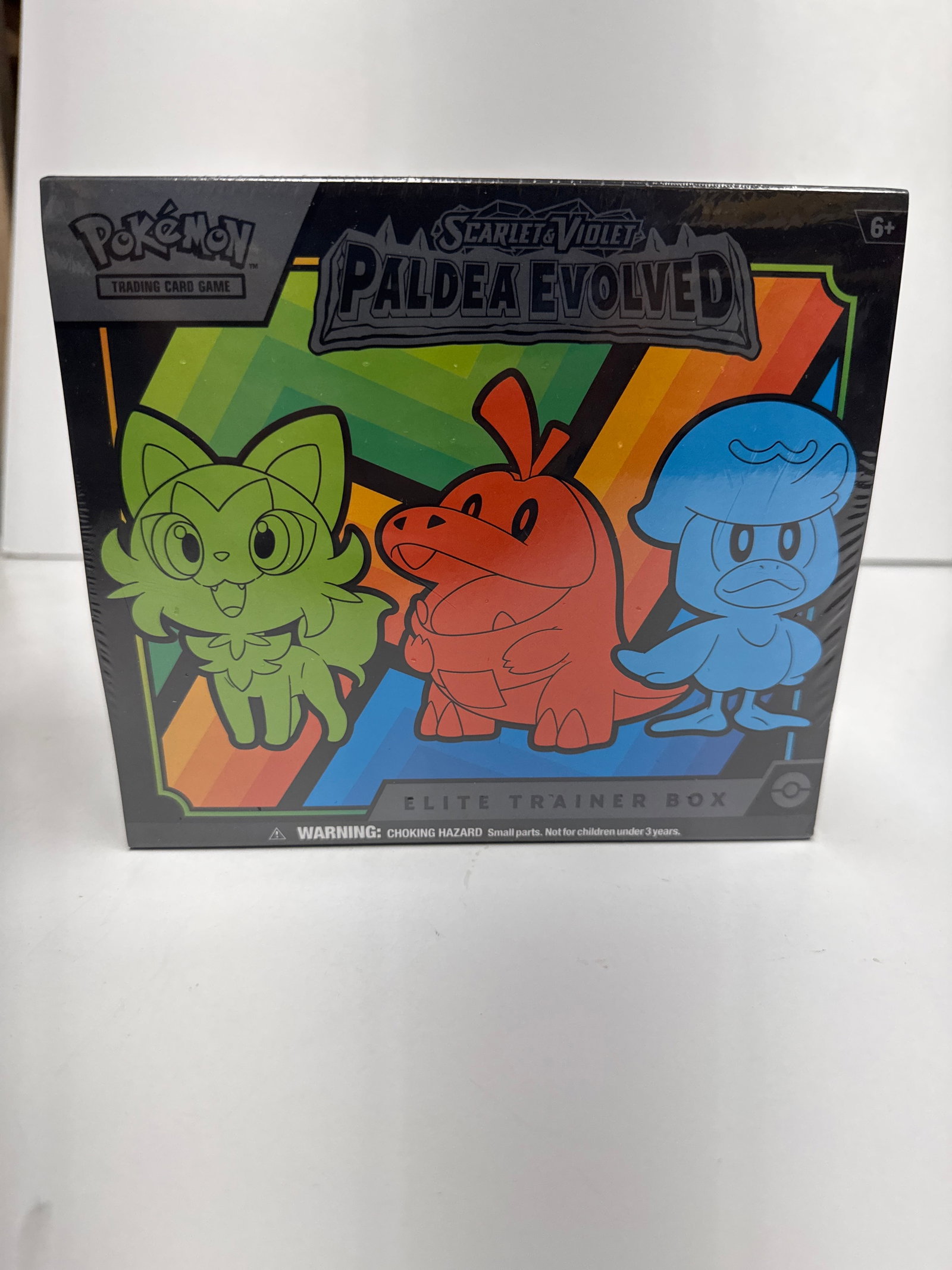 Pokemon Scarlet & Violet Paldea Evolved Elite Trainer Box: This Pokemon Scarlet & Violet - Paldea Evolved Elite Trainer Box features a full-art foil promo card of Pikachu, 5 Scarlet & Violet - Paldea Evolved booster packs, 65 card sleeves, a player's guide, a