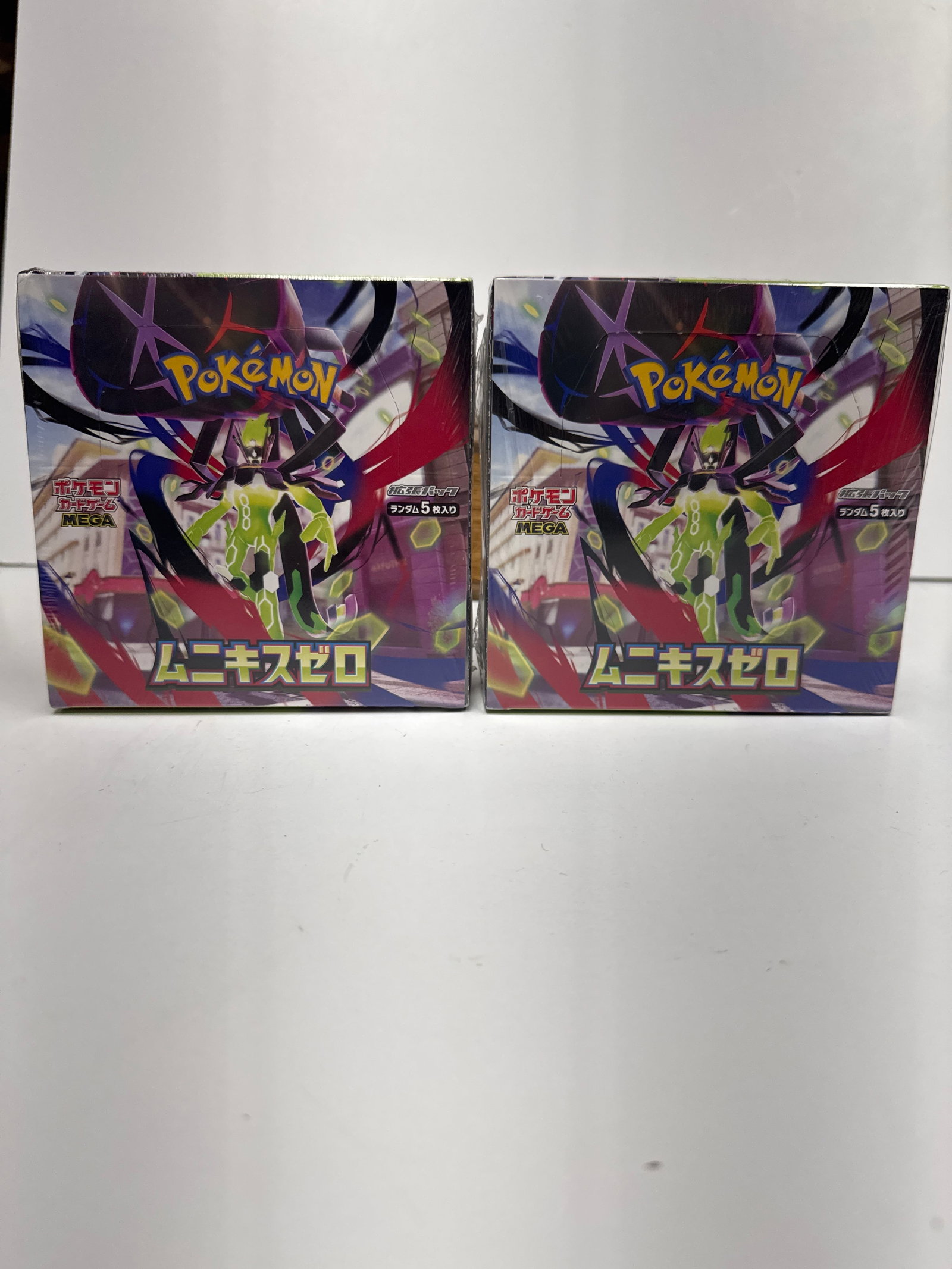Two Pokemon Card Game Sword & Shield Expansion Pack "Munikis Zero" Booster Boxes: This lot features two sealed booster boxes of the Pokemon Card Game Sword & Shield Expansion Pack, "Munikis Zero." Each box contains 30 booster packs, offering a chance to collect 