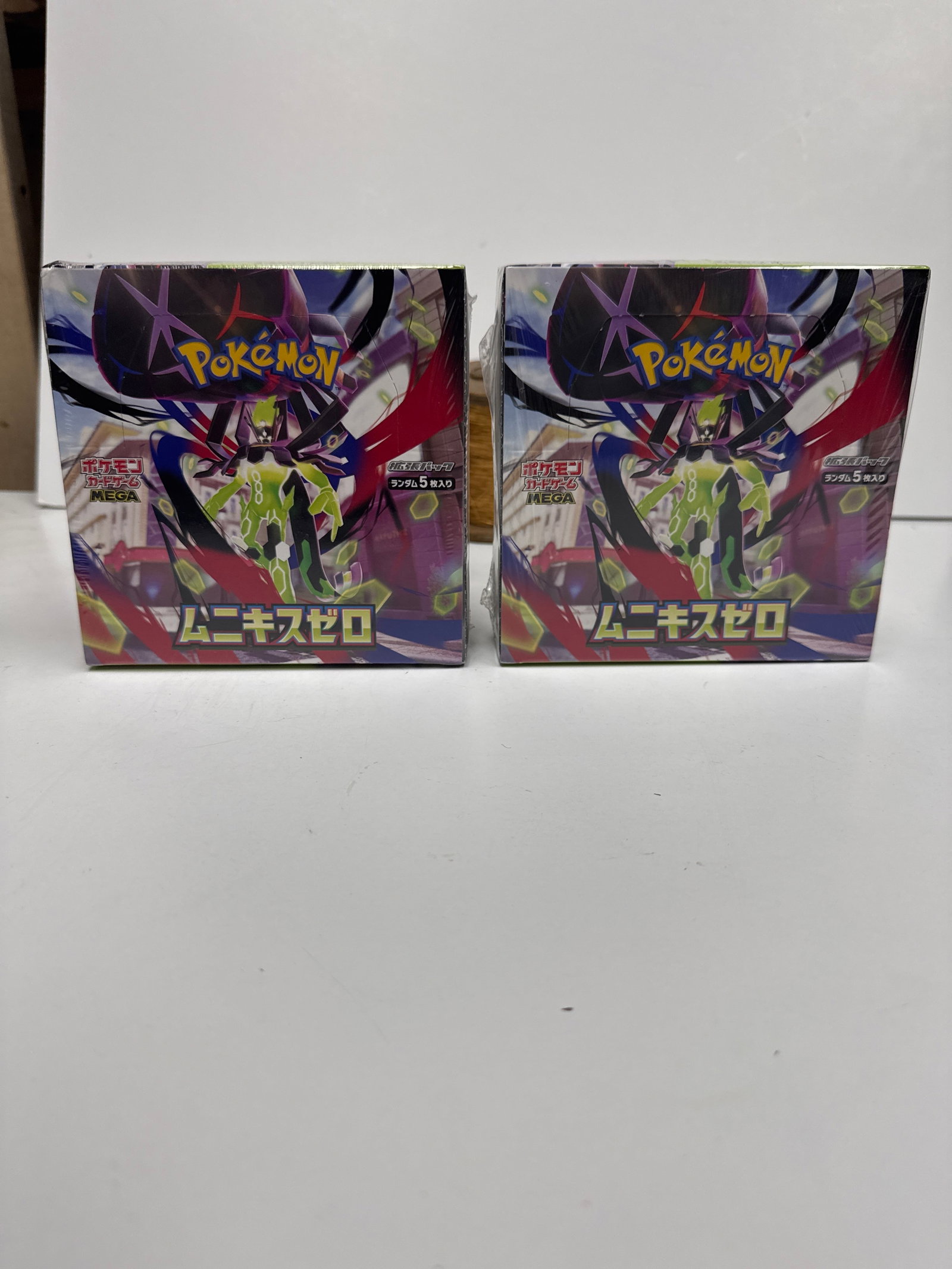 Two Pokemon Card Game Sword & Shield Expansion Pack "Munikis Zero" Booster Boxes: This lot features two sealed booster boxes of the Pokemon Card Game Sword & Shield Expansion Pack, "Munikis Zero" Each box contains 30 packs, with 5 cards per pack. These boxes are made 