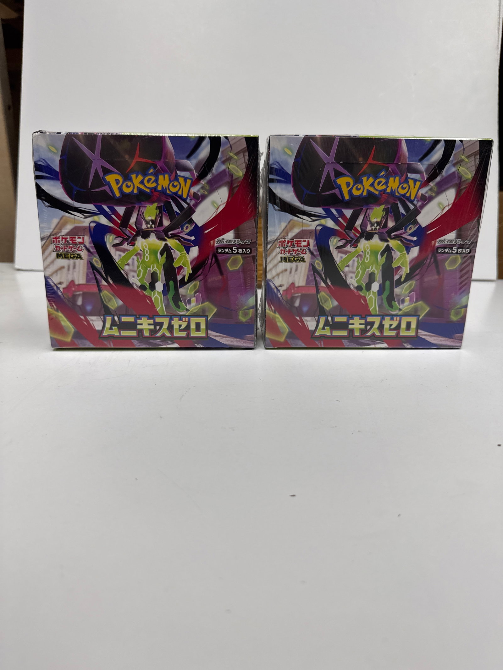 Two Pokemon Card Game Sword & Shield Series Booster Boxes: This lot features two sealed booster boxes for the Pokemon Card Game, Sword & Shield series. Each box contains 30 packs, with each pack containing 5 cards. The artwork on the boxes depicts the legenda