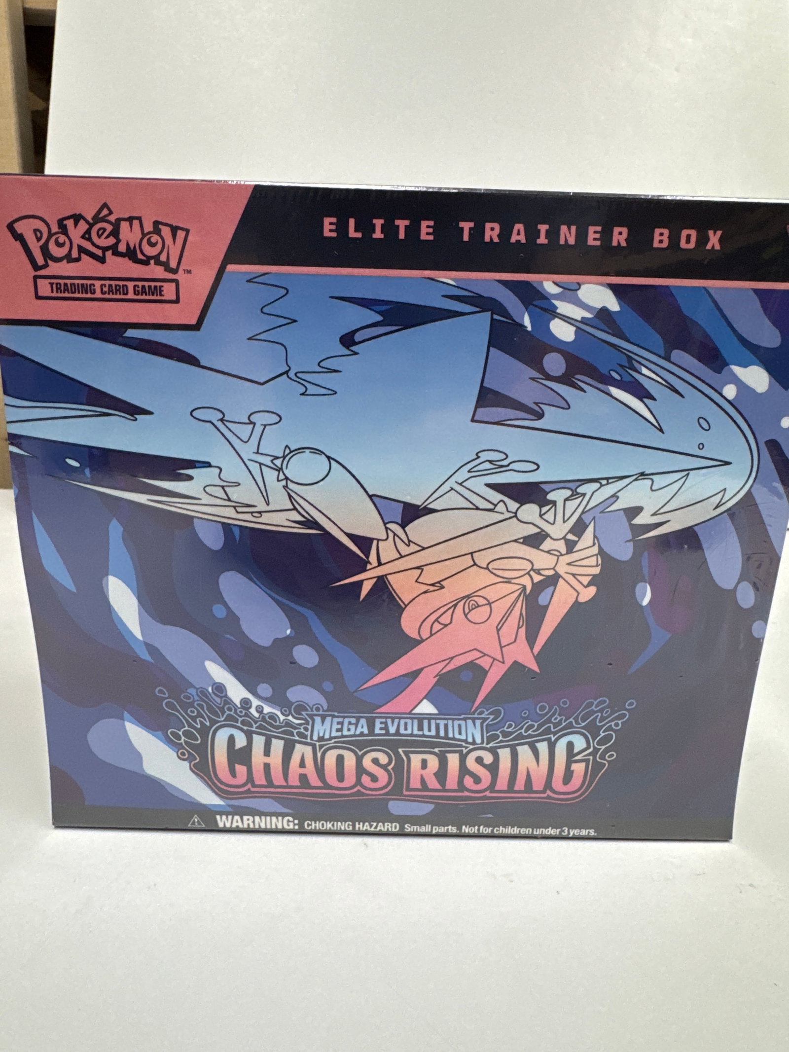 Pokemon TCG: Mega Evolution Chaos Rising Elite Trainer Box: Sealed Pokemon TCG: Mega Evolution Chaos Rising Elite Trainer Box. Includes 10 booster packs, 1 full-art promo card featuring Fennekin, 65 card sleeves, 1 player's guide, 6 damage-counter dice, 1 comp