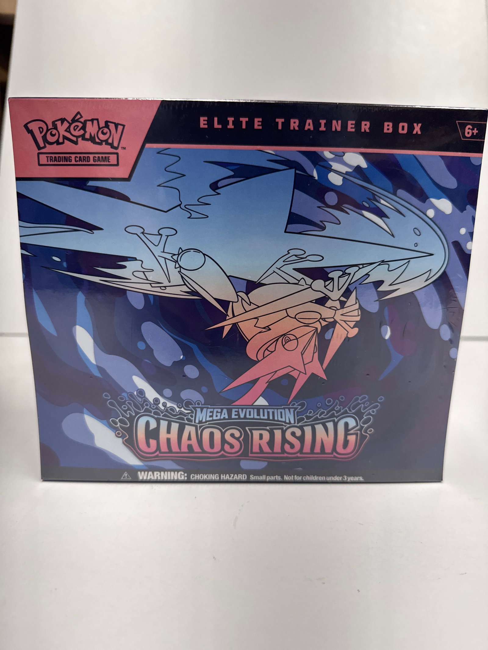 Pokemon TCG: Mega Evolution Chaos Rising Elite Trainer Box: This is a sealed Pokemon Trading Card Game: Mega Evolution Chaos Rising Elite Trainer Box. It includes 9 booster packs, 1 full-art promo card featuring Fennekin, 65 card sleeves, 45 Energy cards, a pl