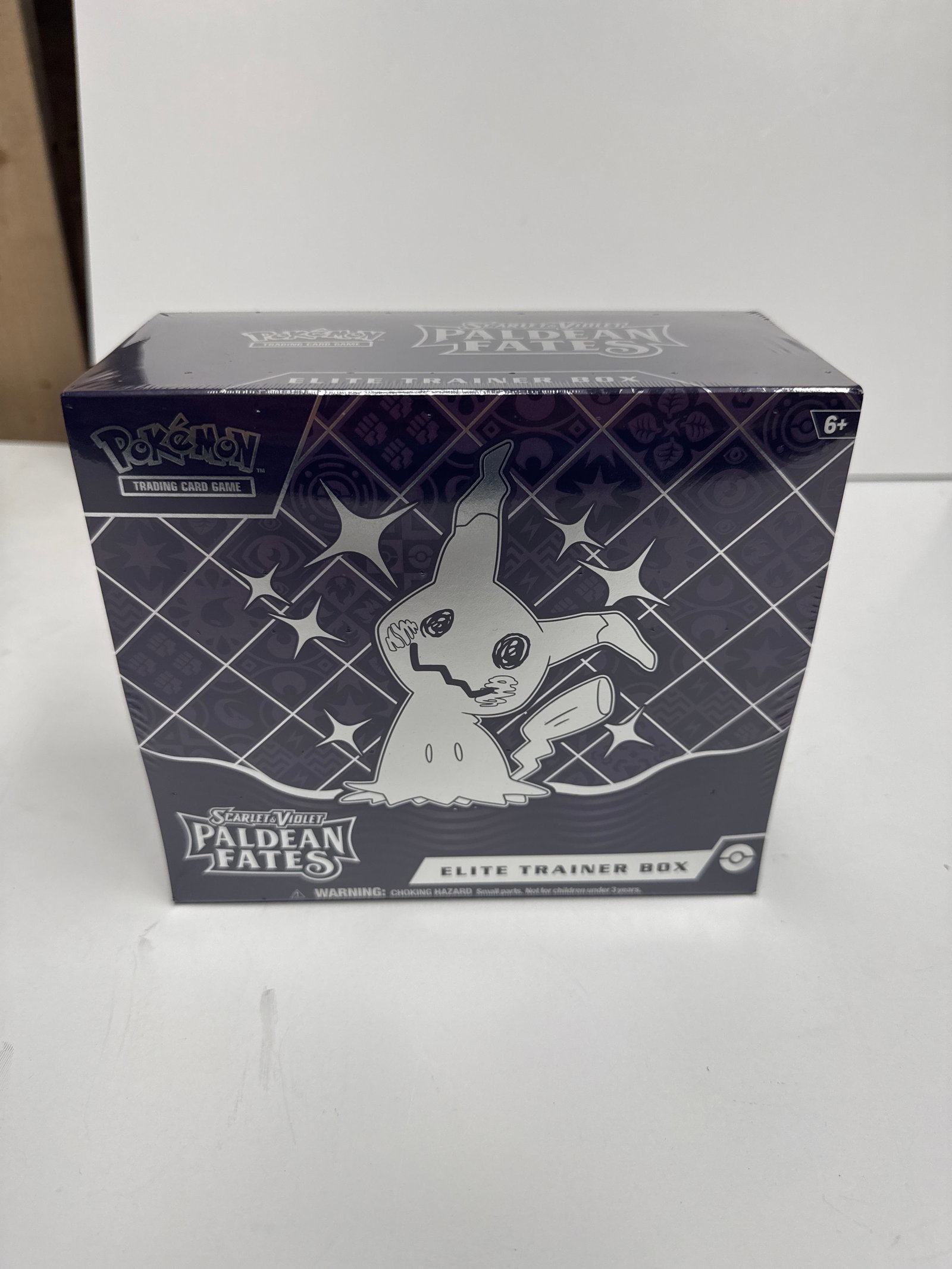 Pokemon Scarlet & Violet Paldean Fates Elite Trainer Box: Sealed Pokemon Scarlet & Violet Paldean Fates Elite Trainer Box. Features Mimikyu on the cover. Includes 9 booster packs, a full-art promo card, sleeves, dice, and more.