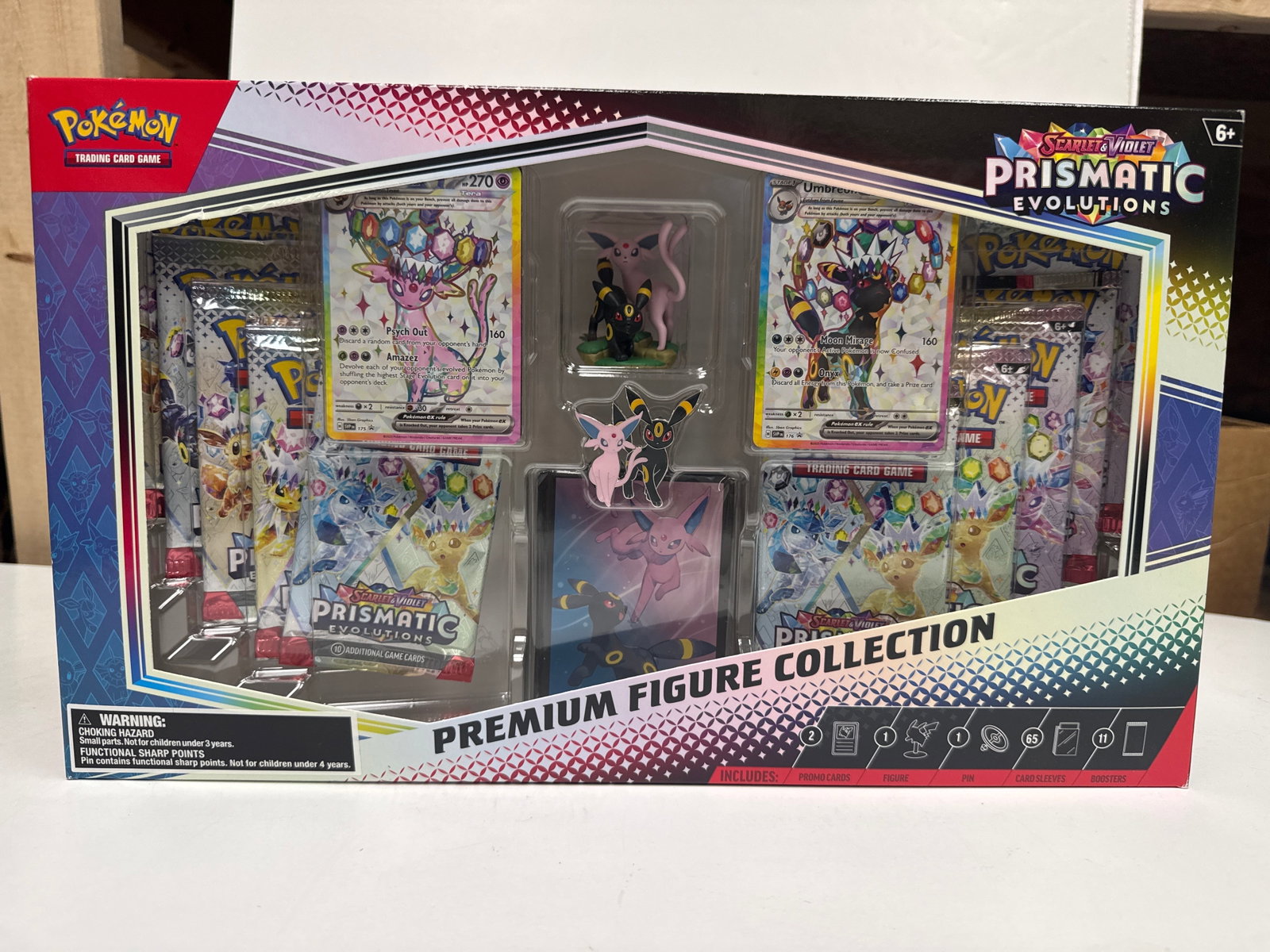 Pokemon Scarlet & Violet Prismatic Evolutions Premium Figure Collection Box: This Pokemon TCG: Scarlet & Violet-Prismatic Evolutions Premium Figure Collection includes: 1 etched foil promo card featuring Espeon-EX, 1 figure featuring Espeon and Umbreon, 1 pin featuring Espeon 
