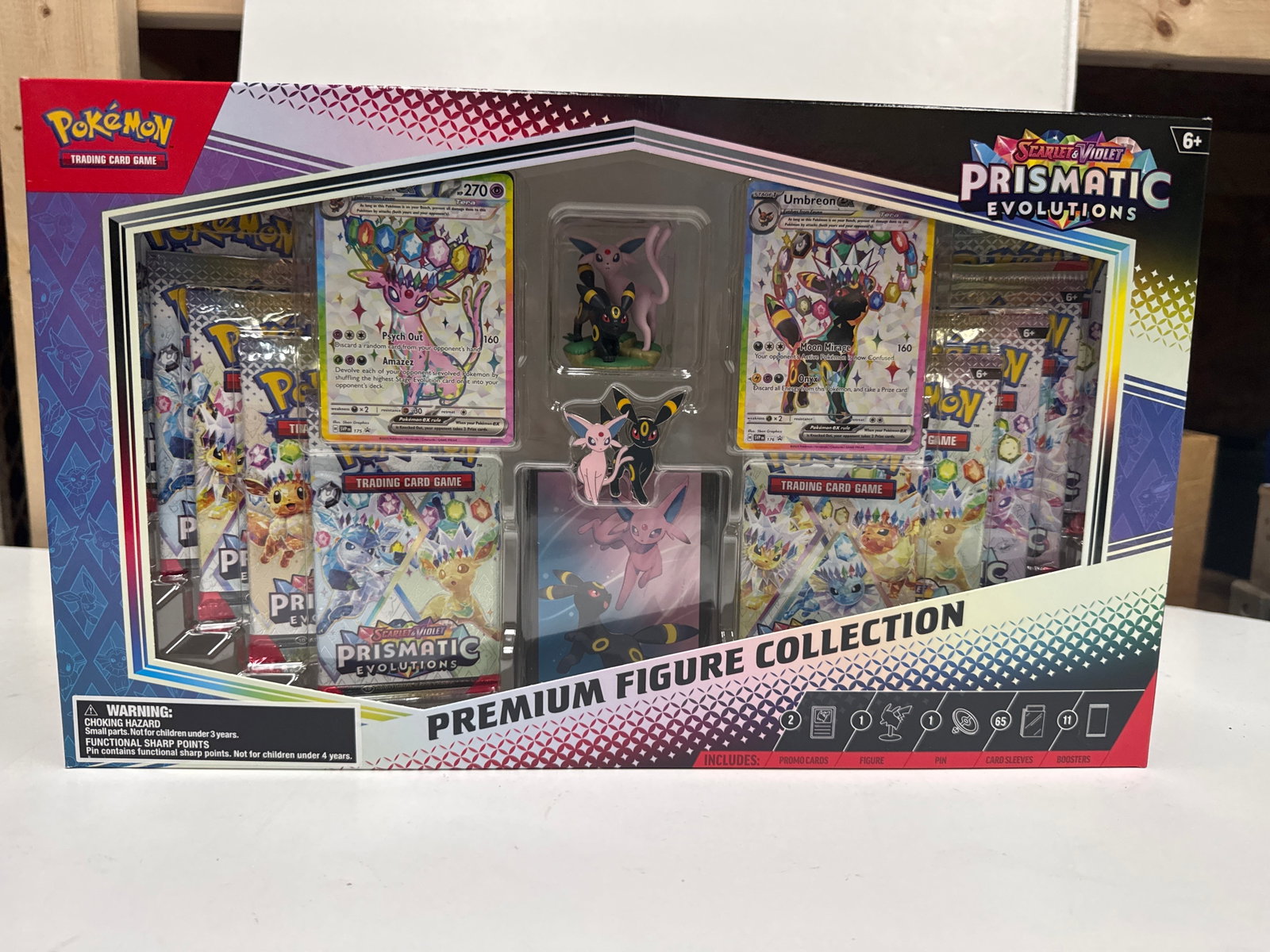 Pokemon Scarlet & Violet Prismatic Evolutions Premium Figure Collection: This Pokemon Scarlet & Violet Prismatic Evolutions Premium Figure Collection features Espeon and Umbreon. It includes 1 etched foil promo card featuring Espeon ex, 1 etched foil promo card featuring U