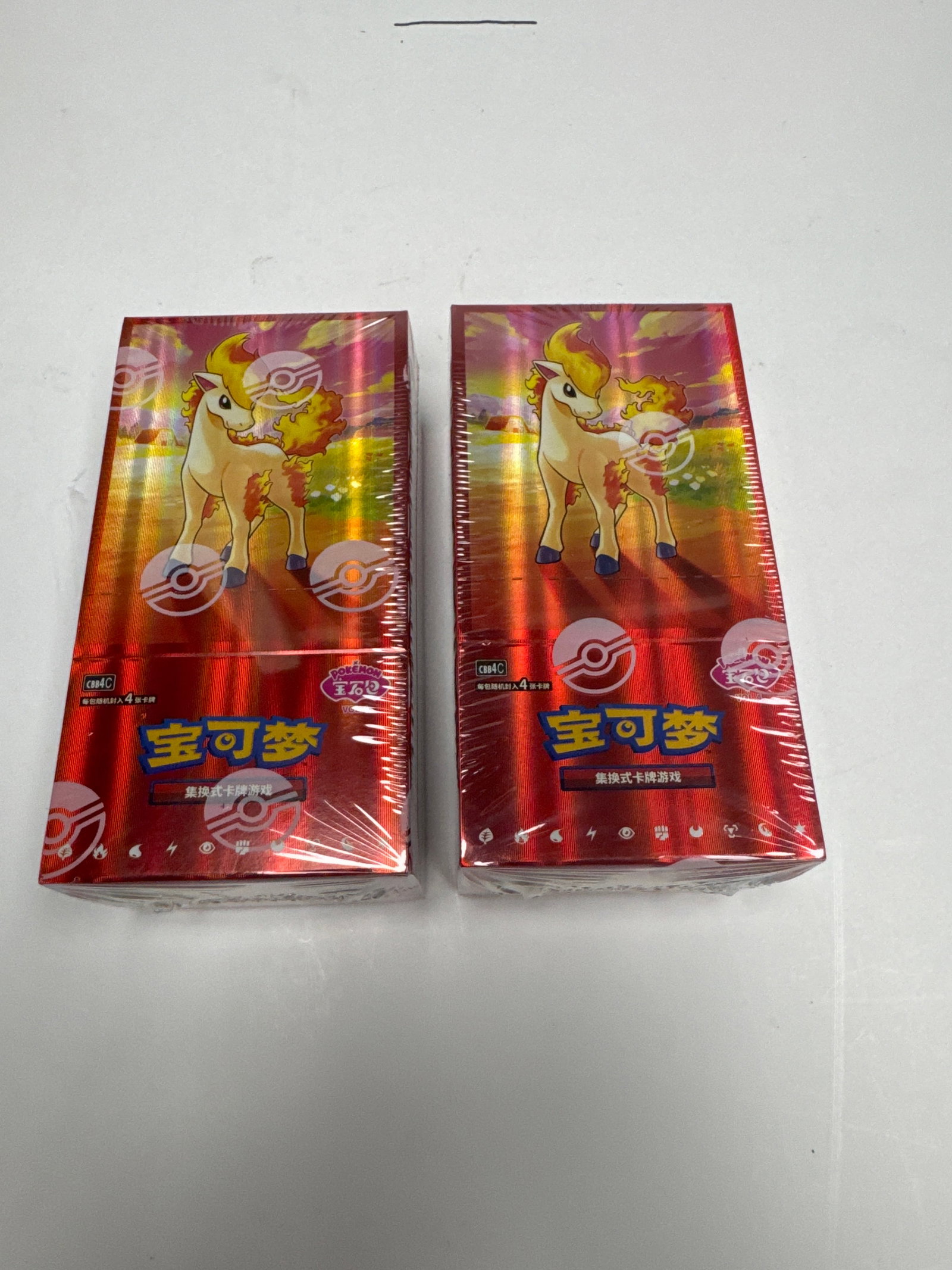 Two Sealed Pokemon Trading Card Game Booster Boxes: This lot features two sealed booster boxes for the Pokemon Trading Card Game. Each box is sealed in its original plastic wrap and displays vibrant artwork featuring Pokemon characters. The boxes are r