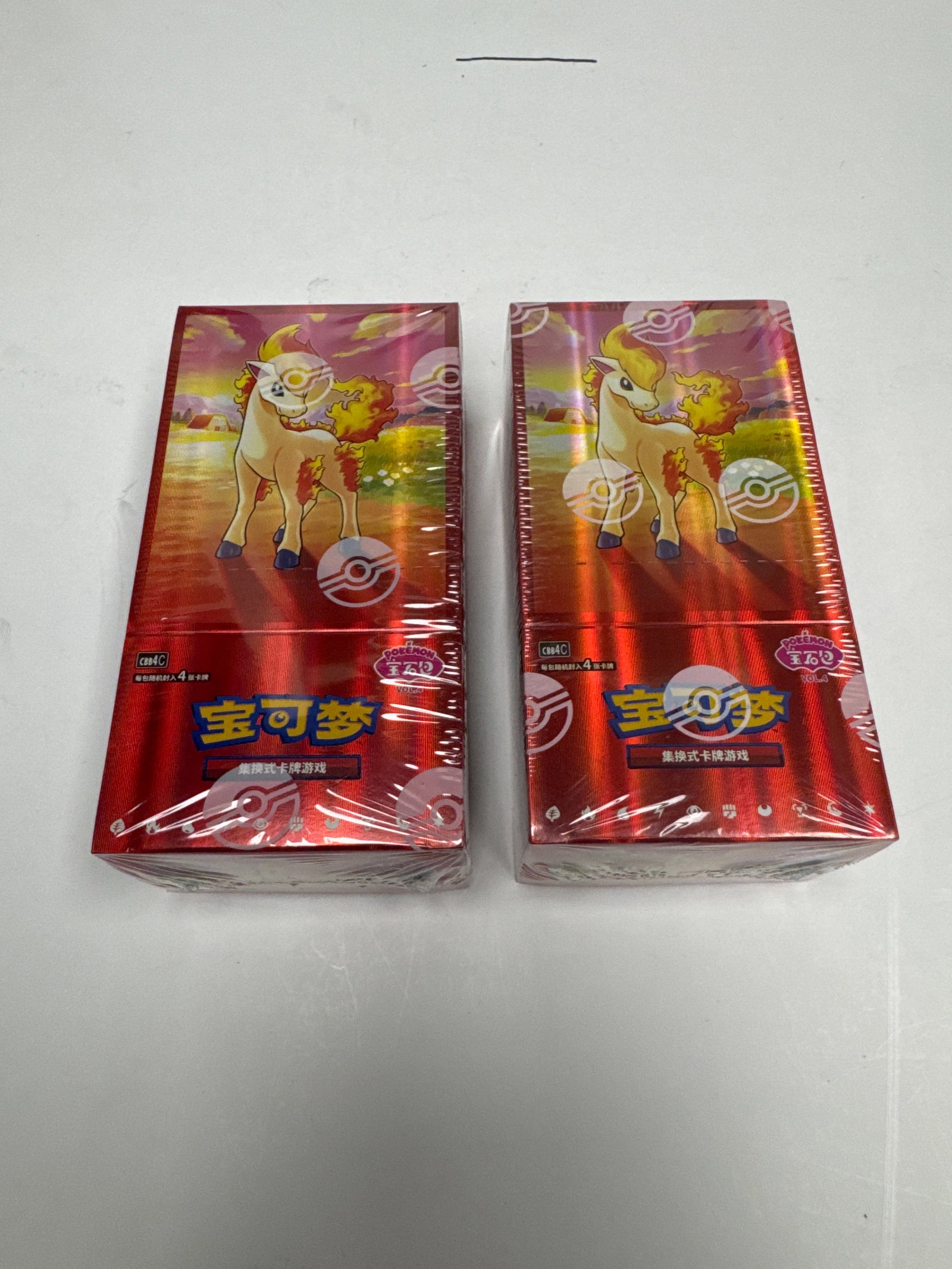 Two Sealed Pokemon Card Booster Boxes: This lot features two sealed booster boxes of Pokemon trading cards. The boxes are red with imagery of Pokemon characters and the Pokemon logo. They appear to be in excellent condition, still sealed i