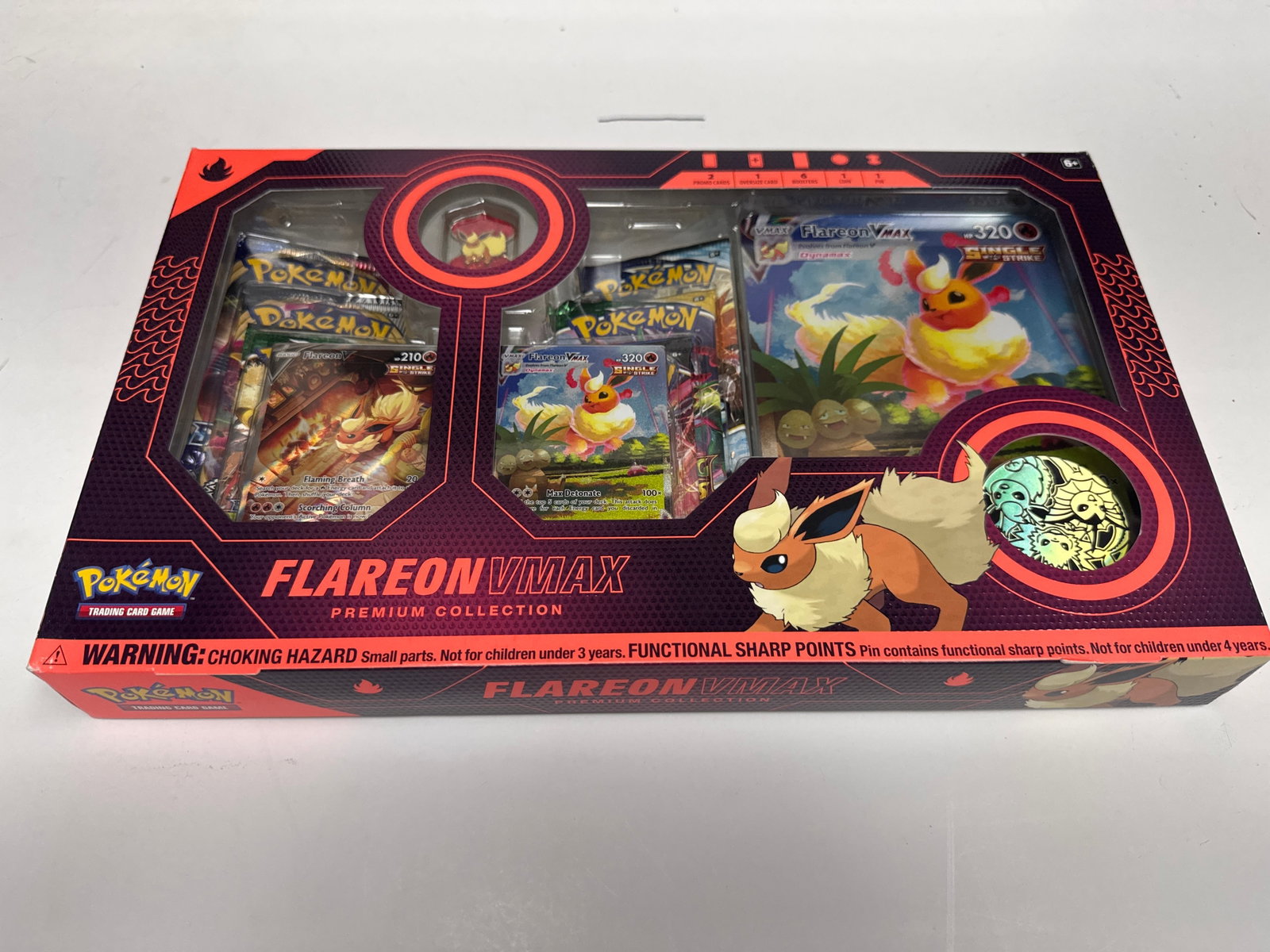 Pokemon TCG Flareon VMAX Premium Collection Box: This Pokemon Trading Card Game Premium Collection box features Flareon VMAX. It includes 1 foil card featuring Flareon VMAX, 1 oversized card featuring Flareon VMAX, 1 metallic coin, 1 pin, 65 card sl