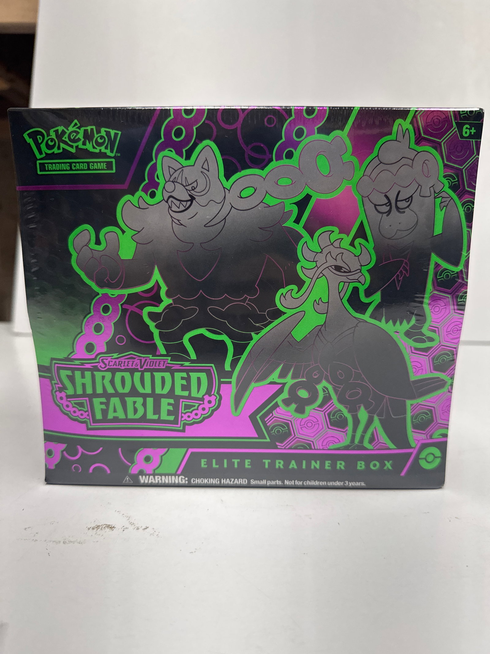 Pokemon TCG Scarlet & Violet Shrouded Fable Elite Trainer Box: This is a sealed Pokemon Trading Card Game Scarlet & Violet Shrouded Fable Elite Trainer Box. It contains 9 booster packs, 65 card sleeves, 45 energy cards, damage-counter dice, and more.