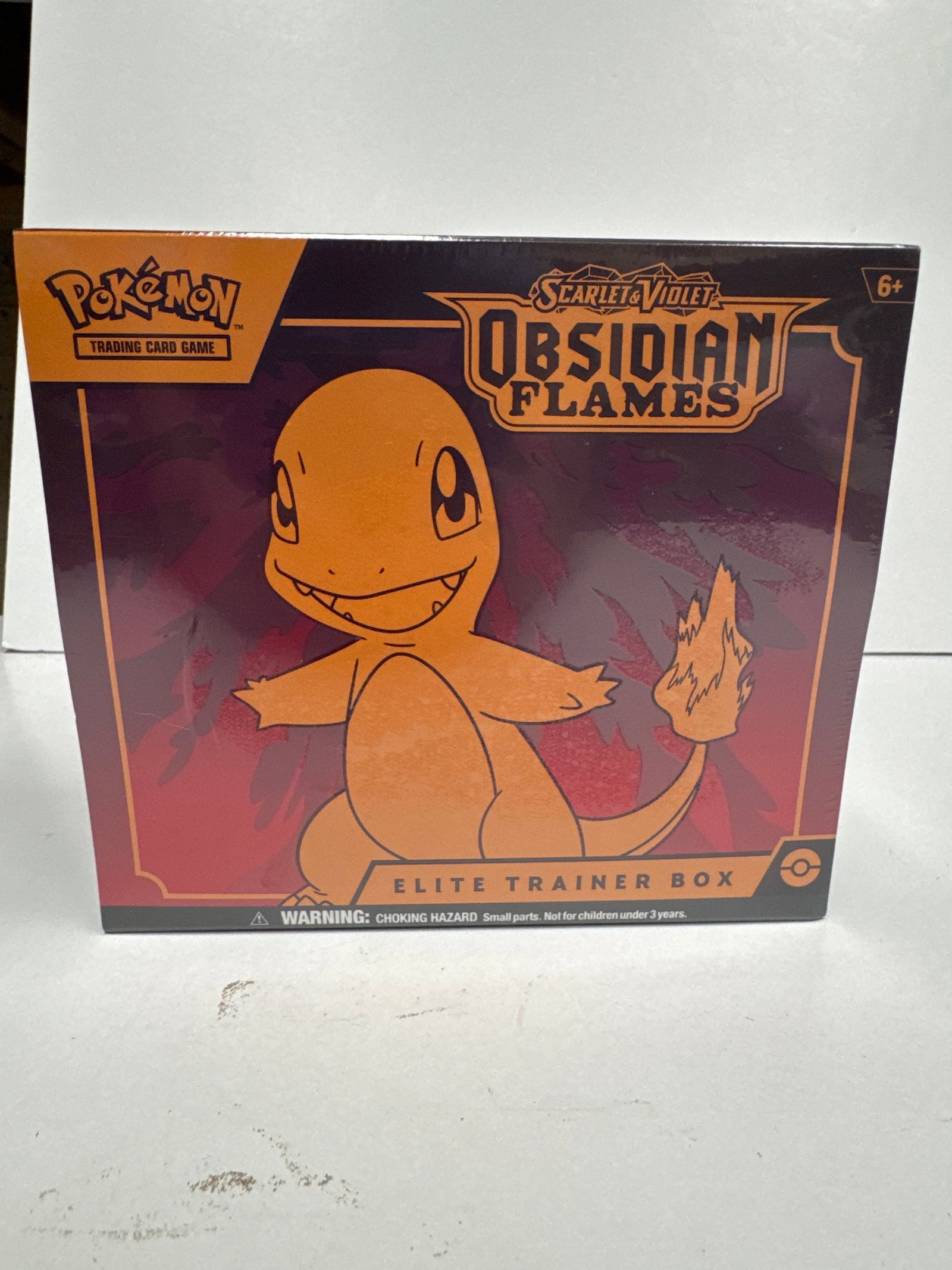 Pokemon Scarlet & Violet Obsidian Flames Elite Trainer Box: Sealed Pokemon TCG Scarlet & Violet Obsidian Flames Elite Trainer Box. Features 9 Scarlet & Violet-Obsidian Flames booster packs, 1 full-art promo card featuring Charmander, 65 card sleeves, 45 TCG En