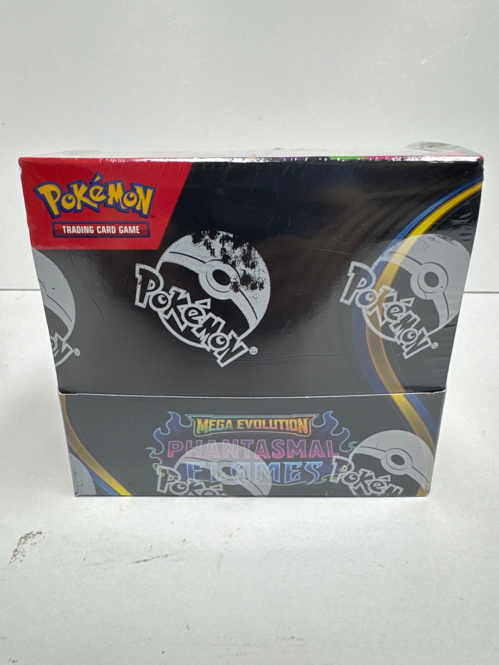 Pokemon TCG Mega Evolution Phantasmals Flames Booster Box: Sealed Pokemon Trading Card Game booster box from the Mega Evolution Phantasmals Flames expansion. Features artwork of Mega Charizard X and Mega Gengar. Contains 120 cards total, with 10 cards per pac