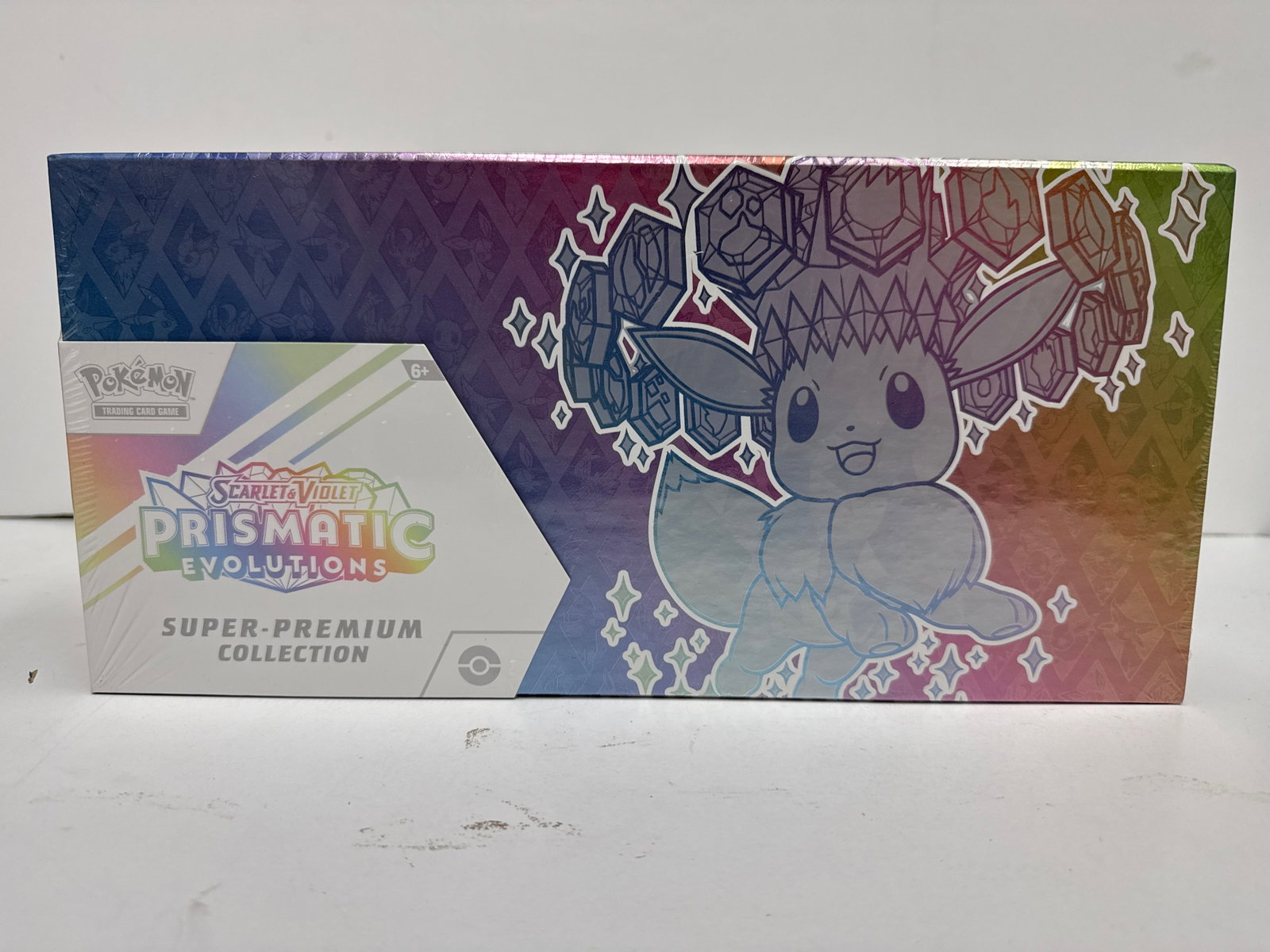 Pokemon TCG Scarlet & Violet Prismatic Evolutions Super-Premium Collection Box: This sealed Super-Premium Collection box from the Pokemon TCG Scarlet & Violet Prismatic Evolutions expansion features Eevee and its Evolutions. It includes a full-art foil promo card, a fuzzy Eevee d