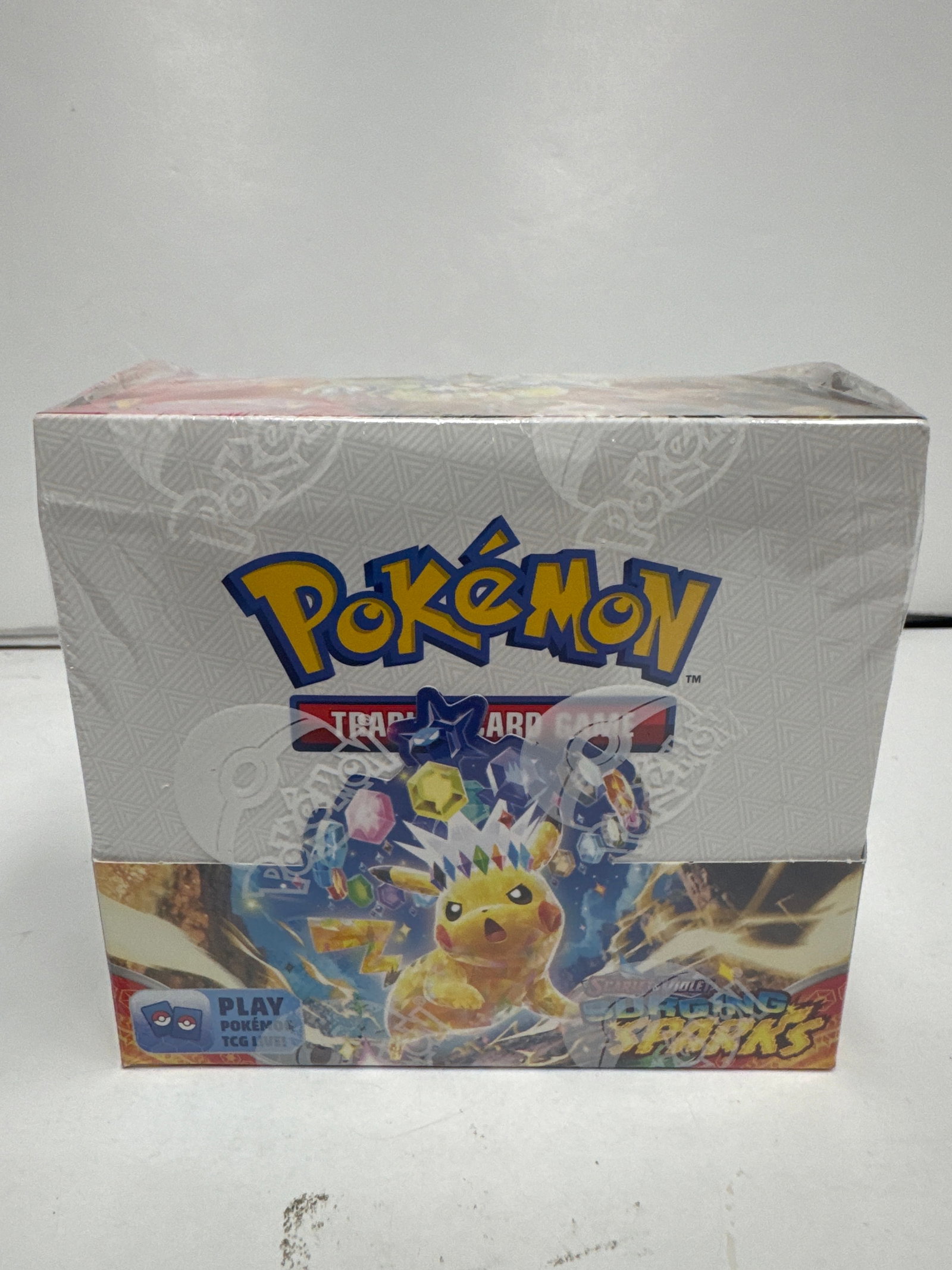 Pokemon Scarlet & Violet - Surging Sparks - Booster Box: Sealed Pokemon TCG booster box from the Scarlet & Violet - Surging Sparks expansion. Features Pikachu and other Pokemon on the packaging. Contains 36 booster packs.