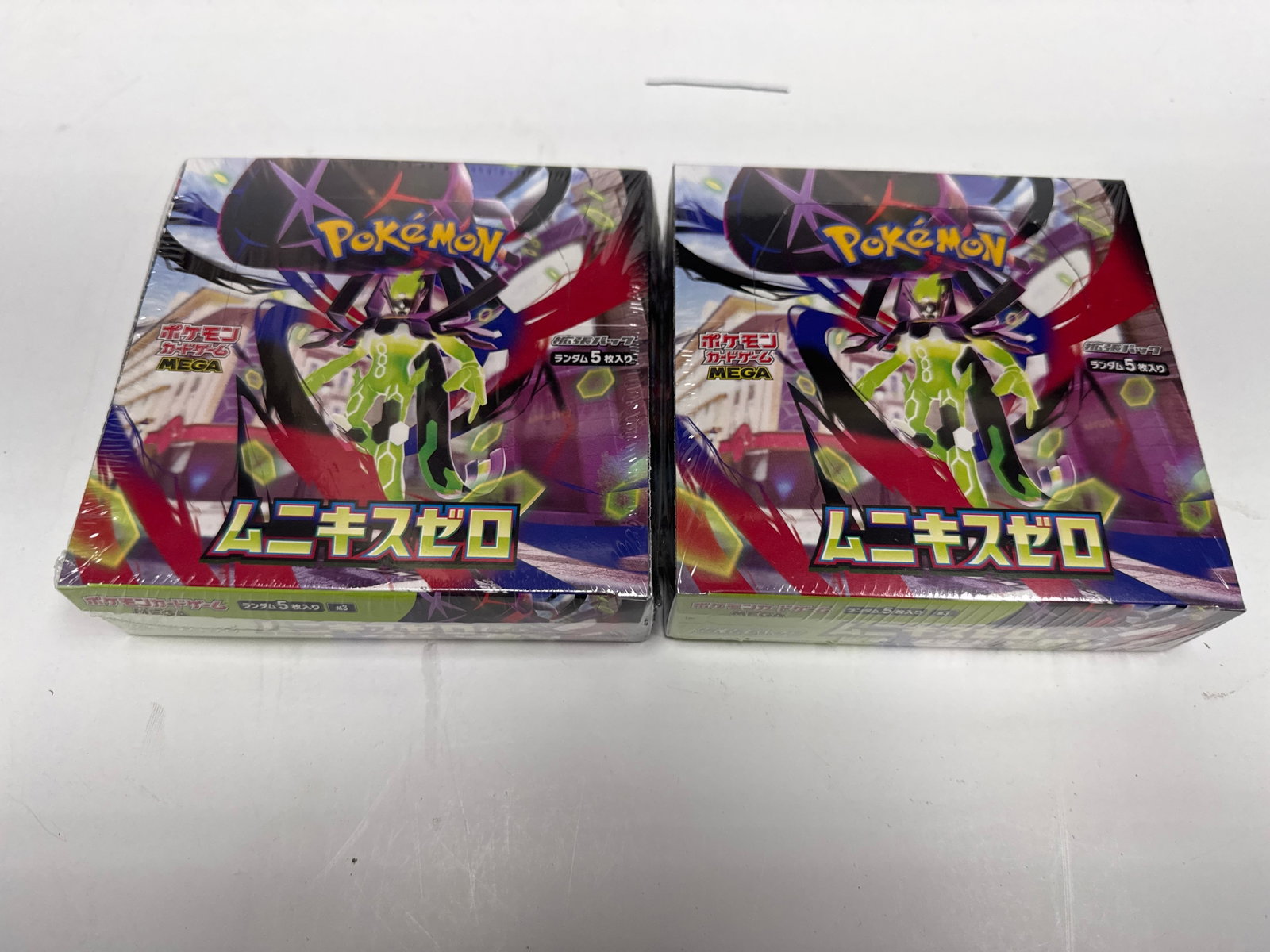 Two Sealed Pokemon Card Game Sword & Shield Expansion Pack "Infinity Zone" Booster Boxes: This lot features two sealed booster boxes of the Pokemon Card Game Sword & Shield expansion pack, titled "Infinity Zone" (Japanese: "Mugen Zone"). Each box contains 30 packs, with 5 cards per pack. T