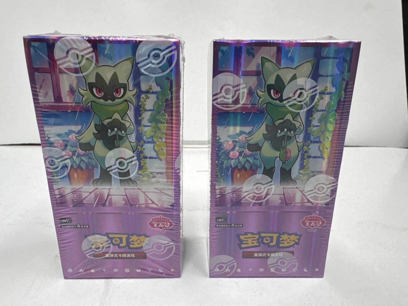 Two Sealed Pokemon Card Game Booster Boxes - Japanese: This lot features two sealed Japanese Pokemon card game booster boxes. Each box is adorned with vibrant artwork featuring the Pokemon Sprigatito and floral motifs. The boxes appear to be in excellent 