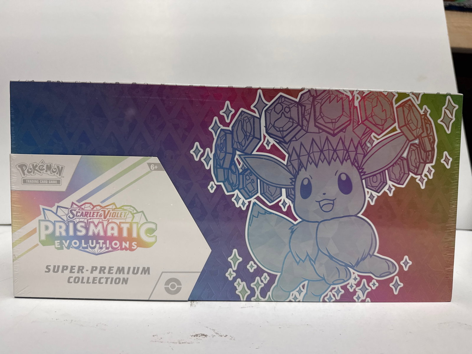 Pokemon Scarlet & Violet Prismatic Evolutions Super-Premium Collection Box: Sealed Pokemon Scarlet & Violet Prismatic Evolutions Super-Premium Collection Box. Features Eevee and its Evolutions, a fuzzy Eevee deck box, playmat, card sleeves, and booster packs from the Scarlet 