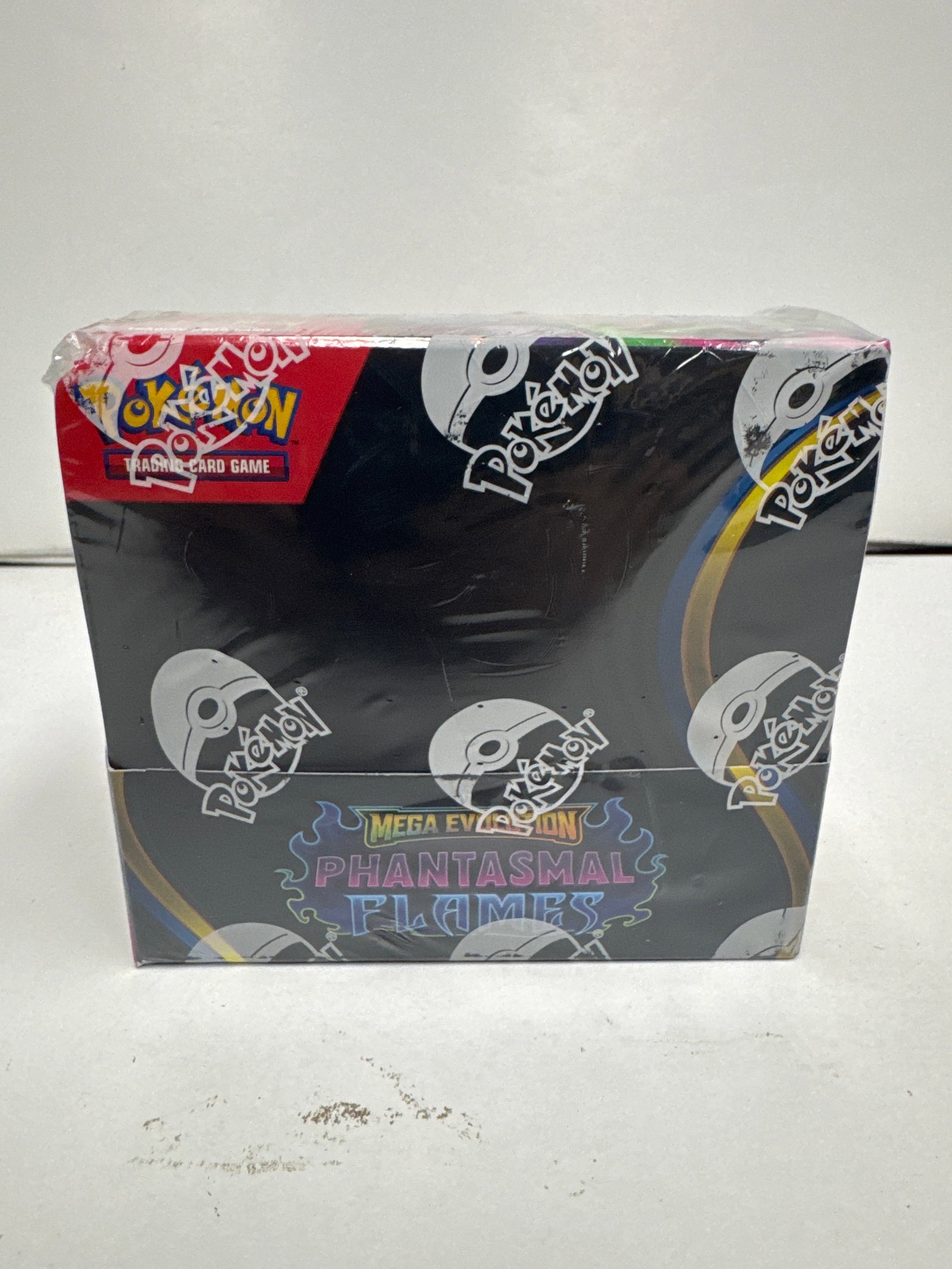 Pokemon TCG Mega Evolution Phantasmals Flames Booster Box: Sealed Pokemon Trading Card Game booster box featuring Mega Evolution Phantasmals Flames. This box contains multiple booster packs, promising exciting new cards and gameplay.